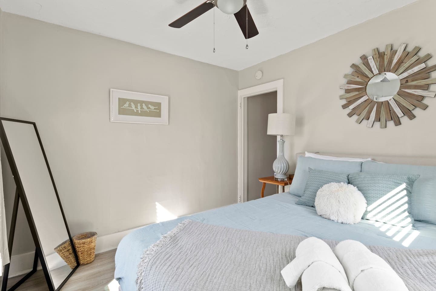 Bedroom with full length mirror and ceiling fan