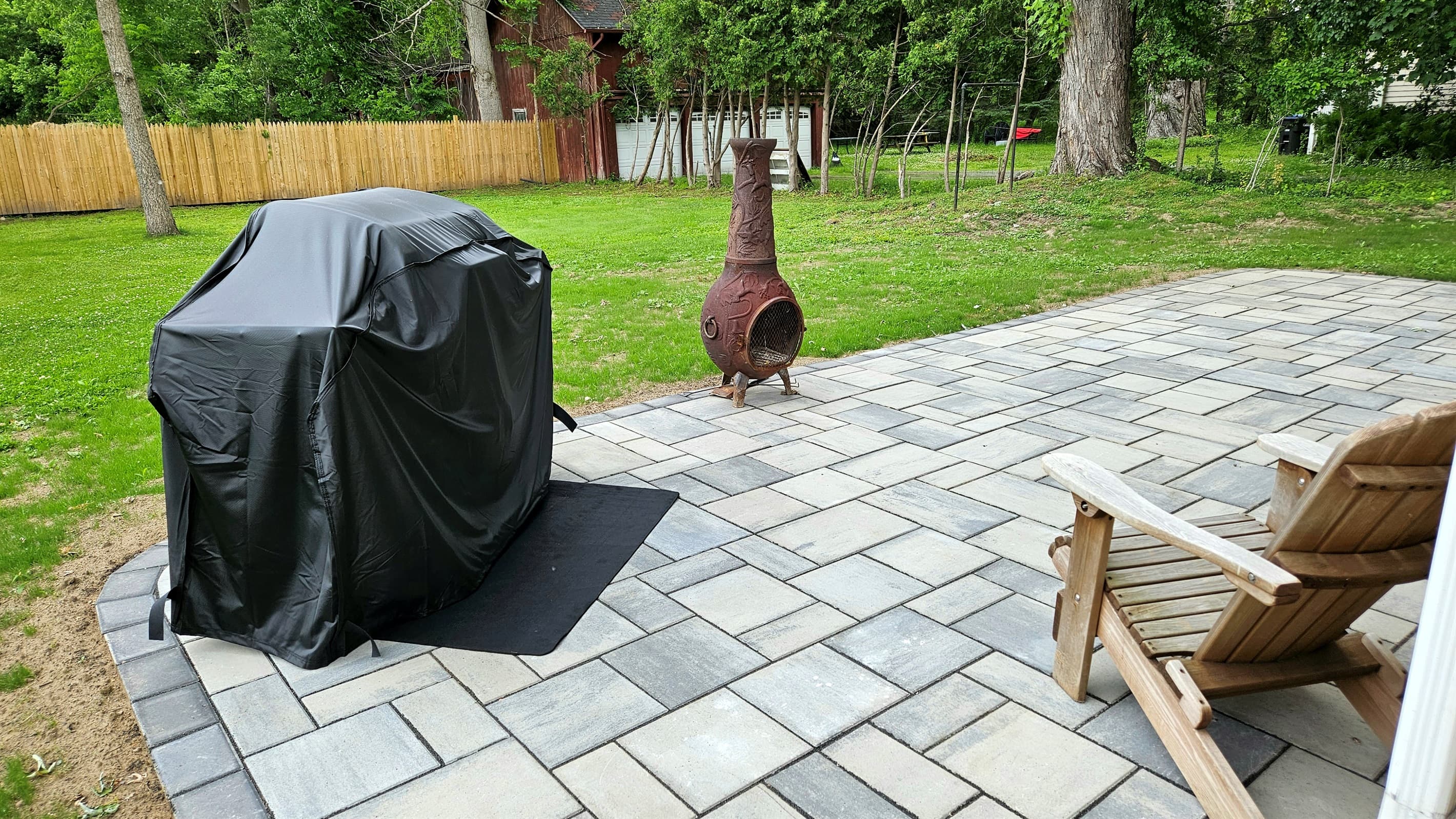 Paved patio with grill and outdoor seating
