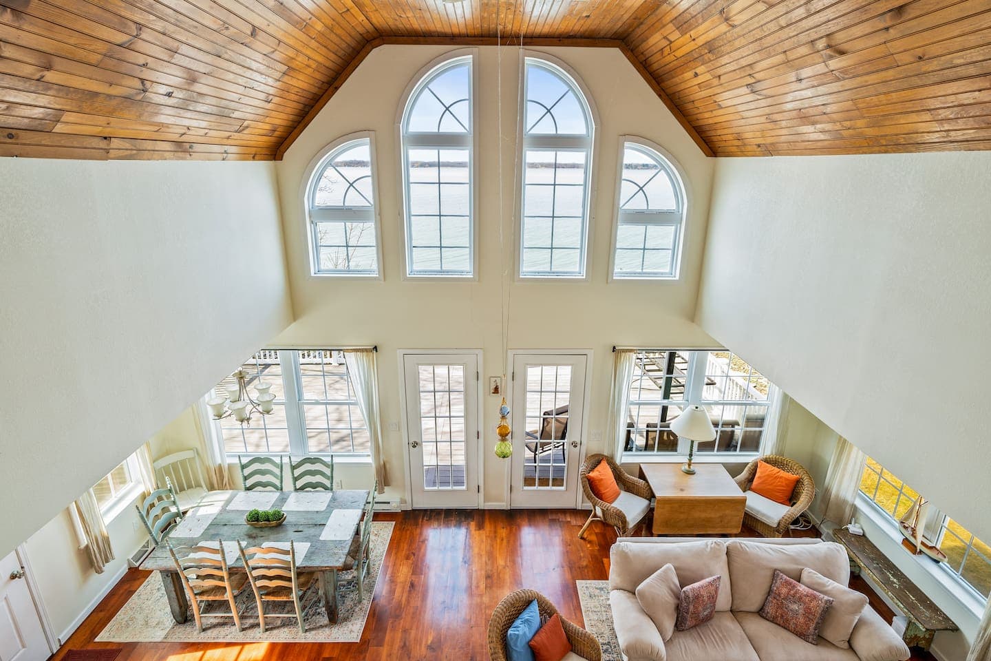 Living room with vaulted ceiling and arched windows