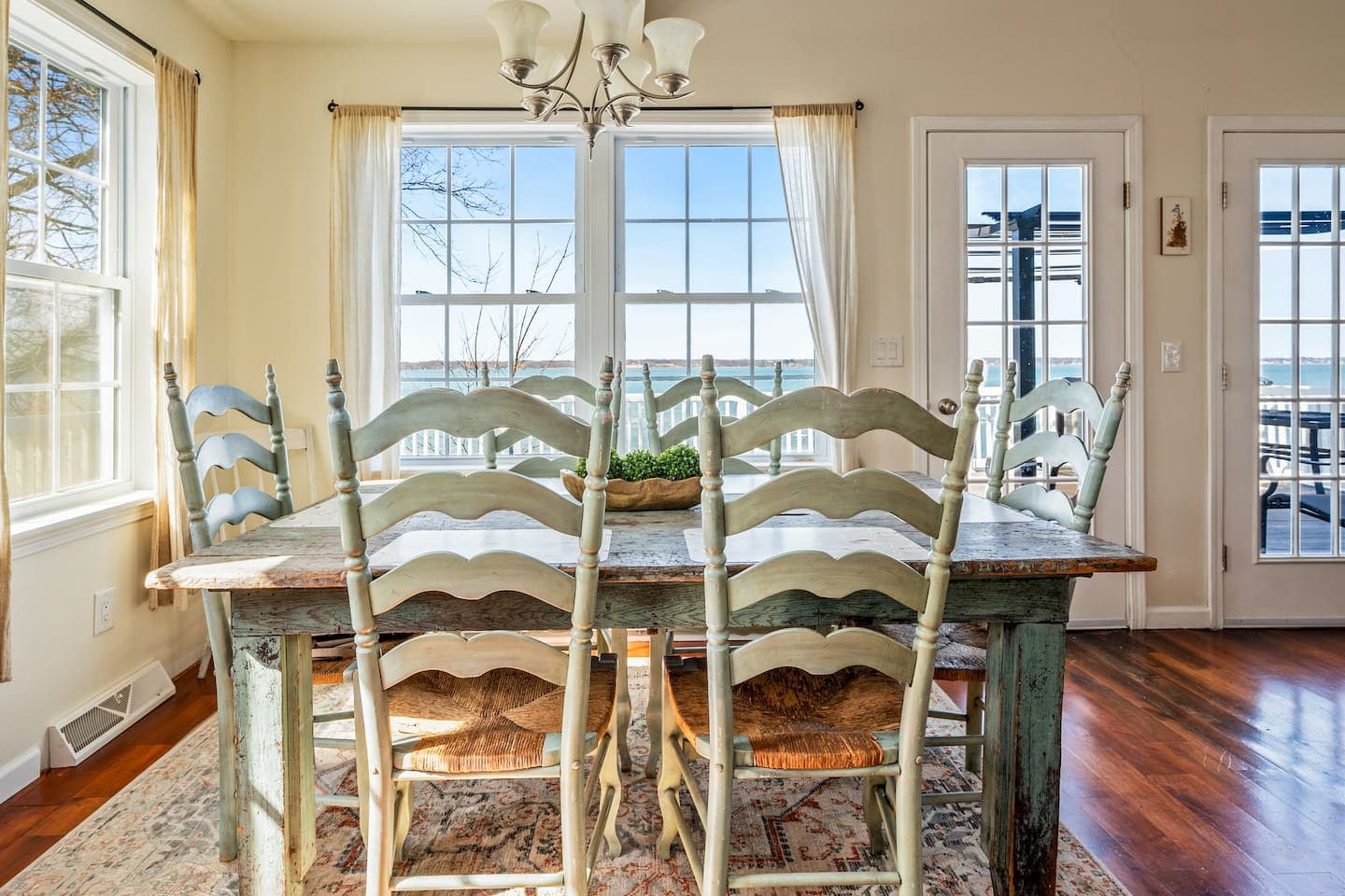 Dining table surrounded by large windows