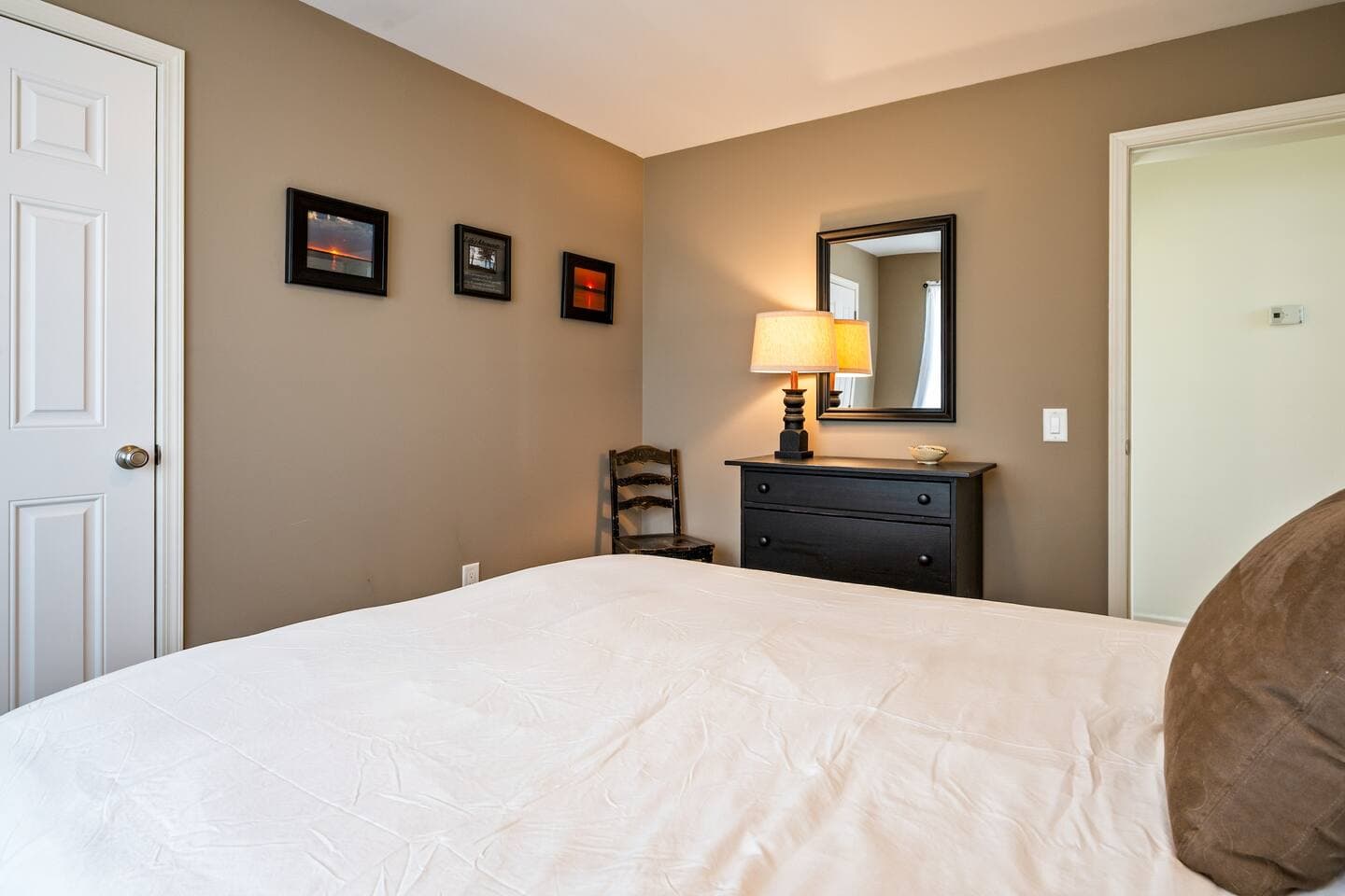 Bedroom dresser with mirror and artwork