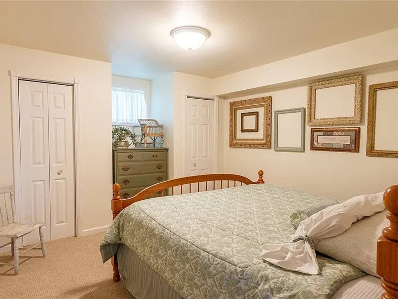 Basement king bedroom with framed artwork