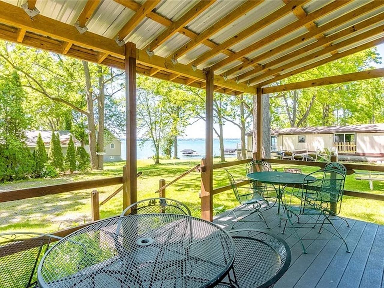 Covered deck with metal dining tables and chairs