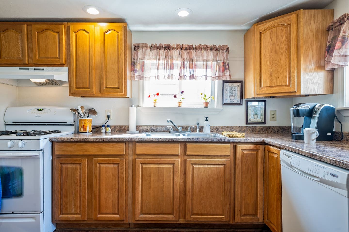 Kitchen with warm wood cabinetry and white backsplash