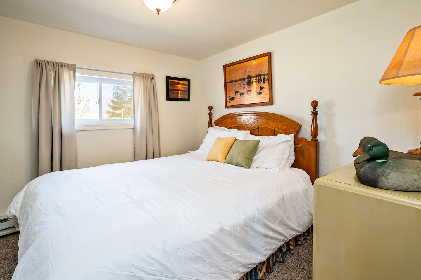 Main-floor queen bedroom with wood bed frame