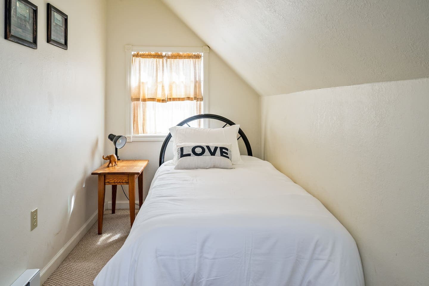 Sunlit bedroom with bedside table