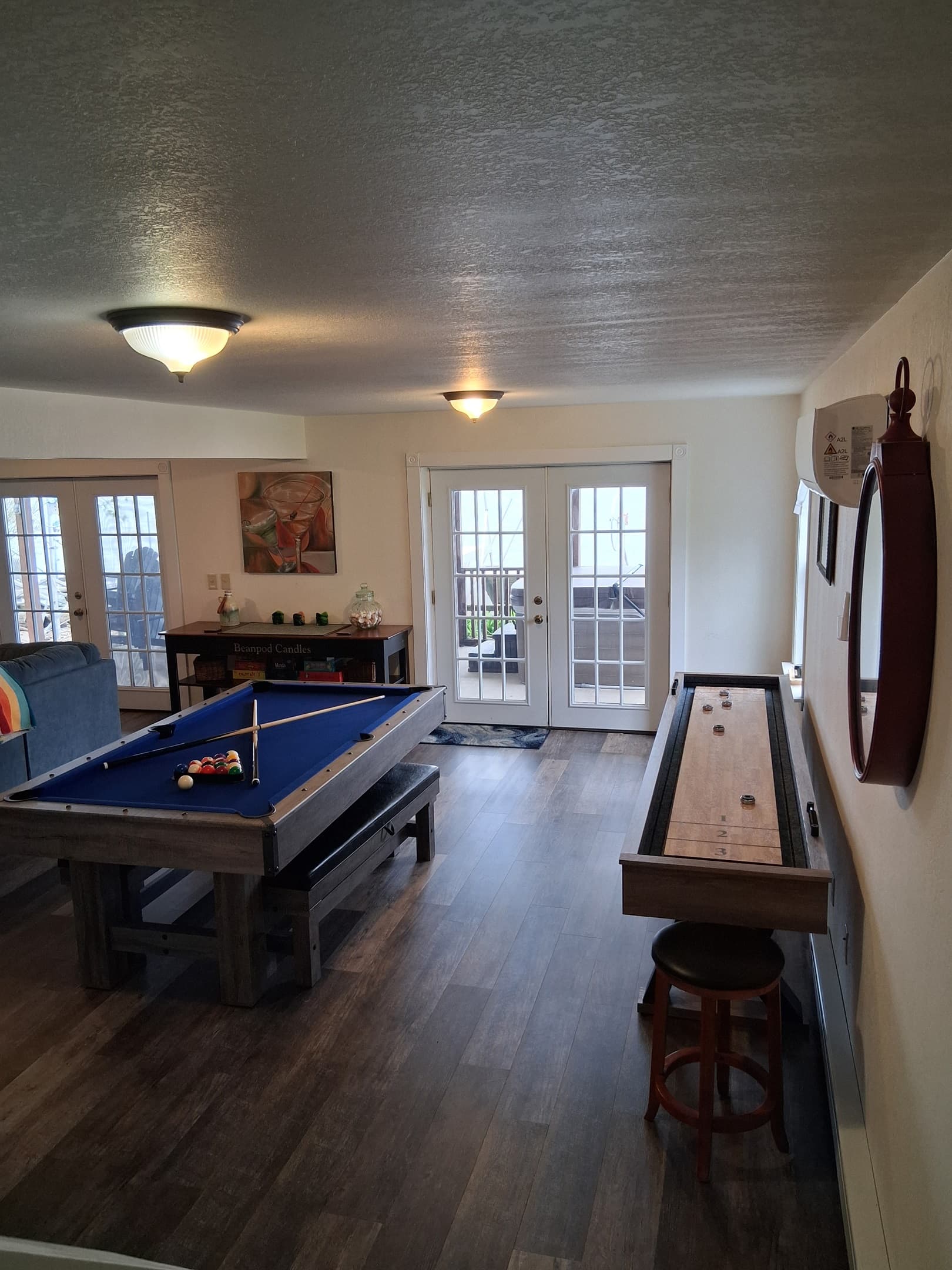 Lower-level game room with multiple table games