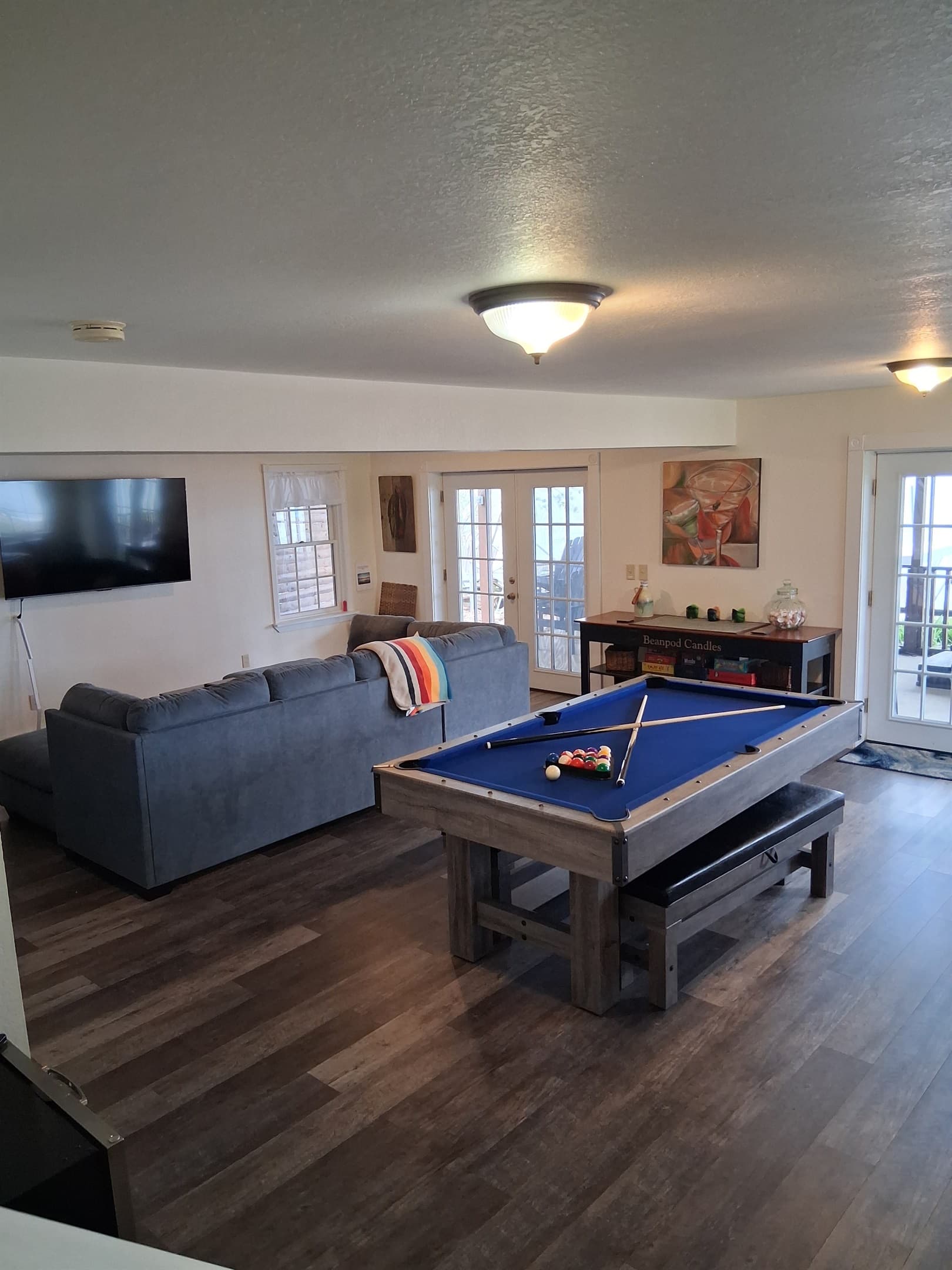 Game room with pool table and sectional sofa