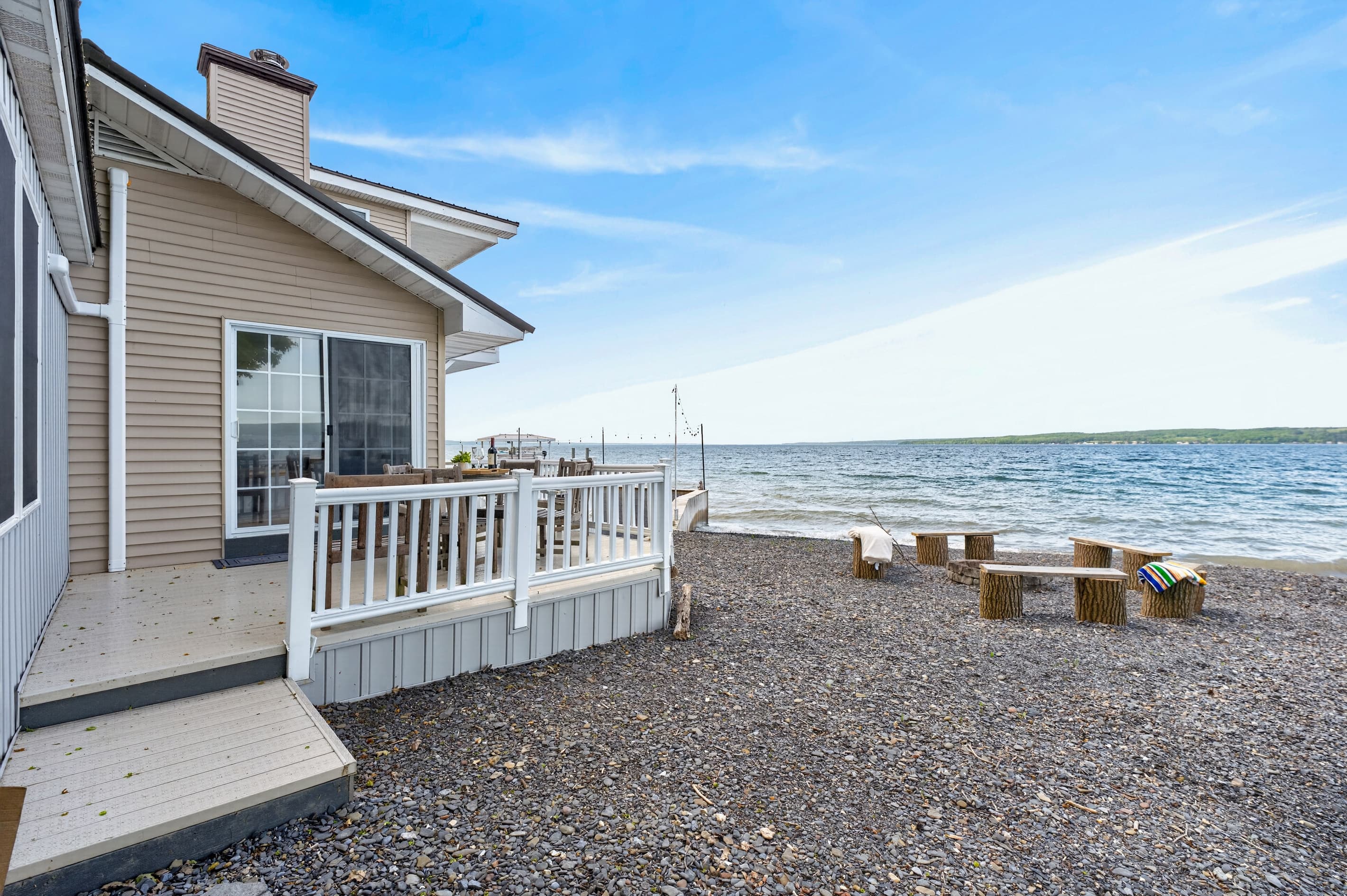 Home exterior along the pebbled shoreline