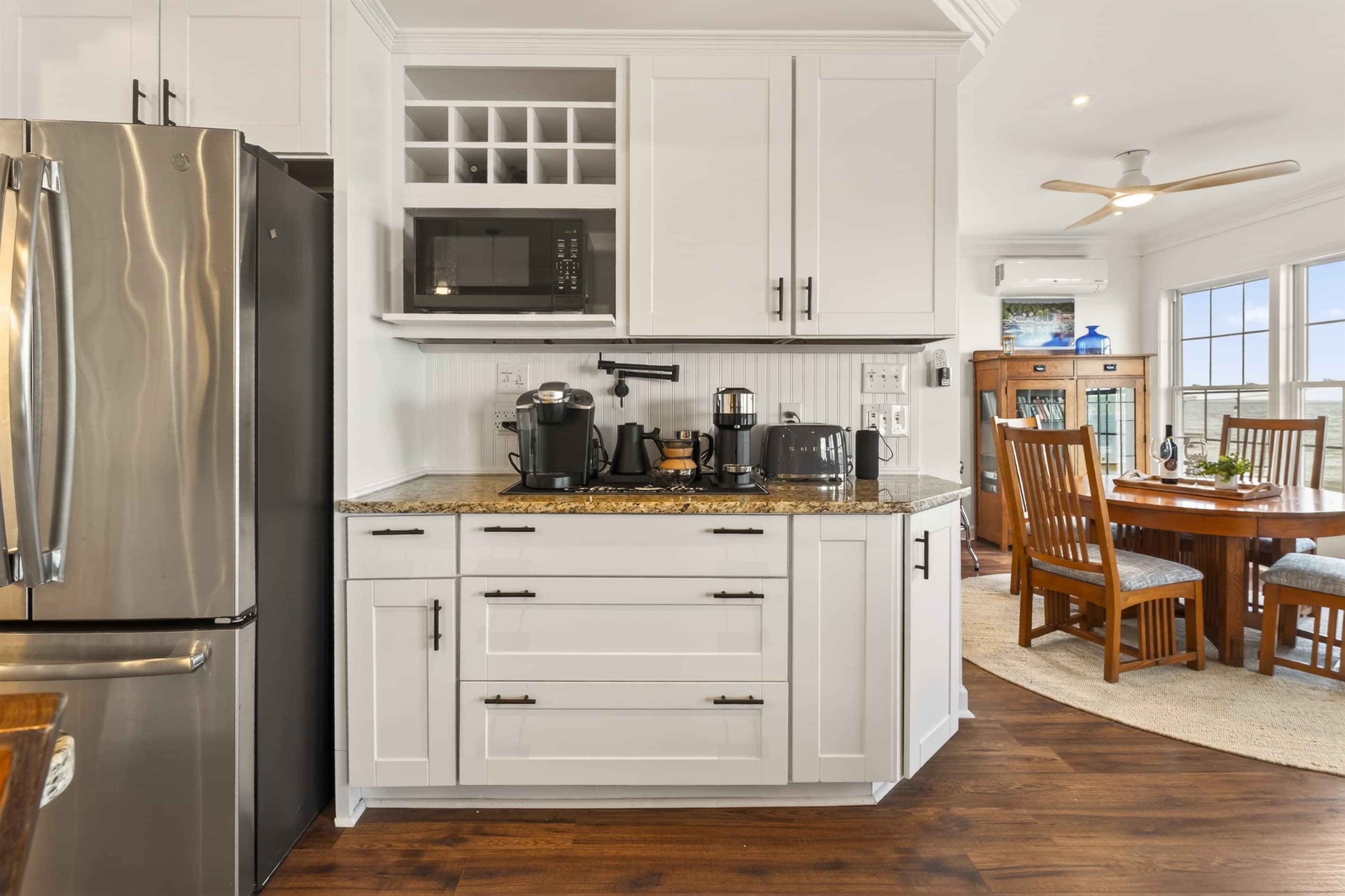 Beverage station with cabinetry and refrigerator