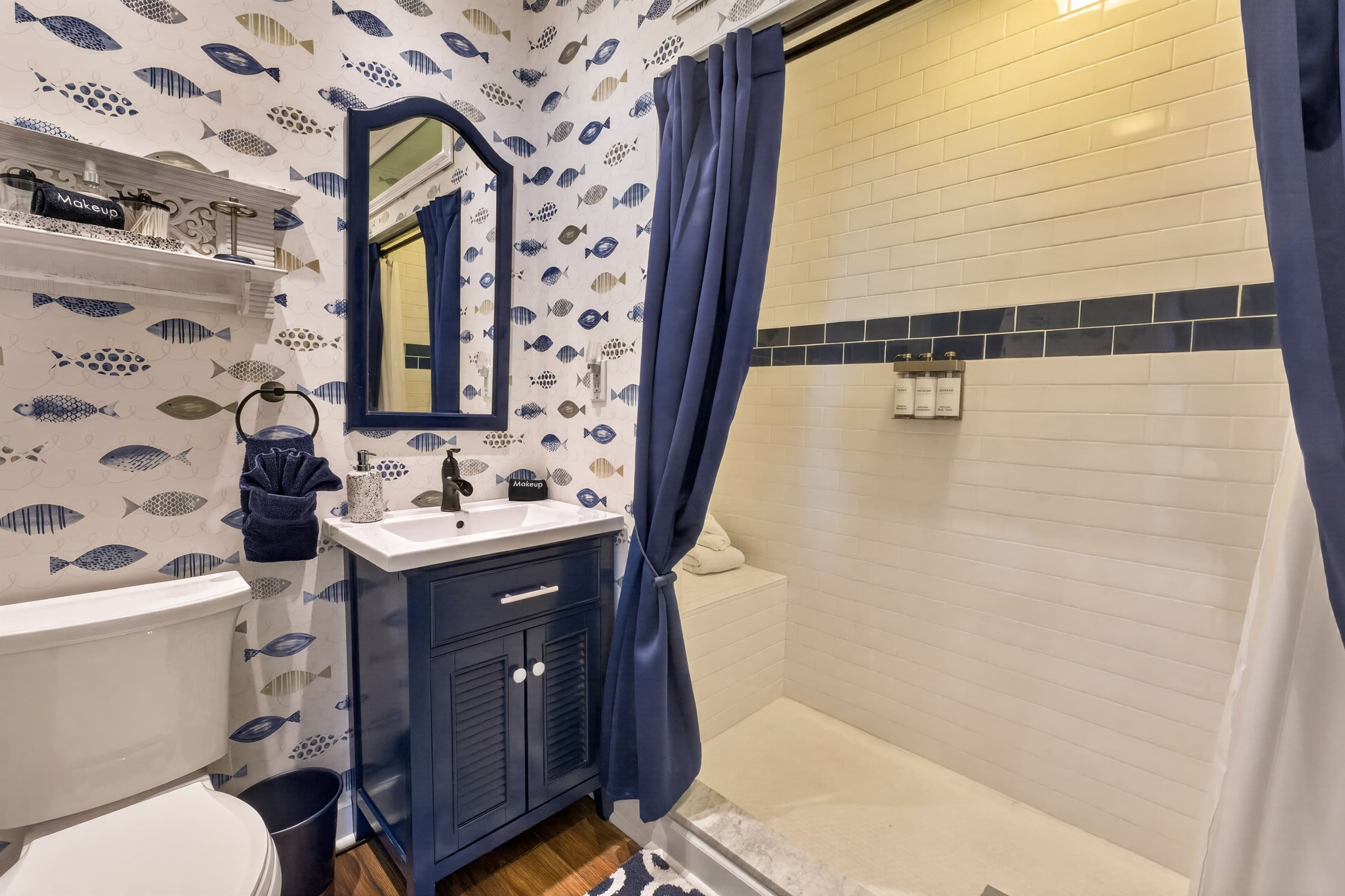 Bathroom with shower and blue furnishings