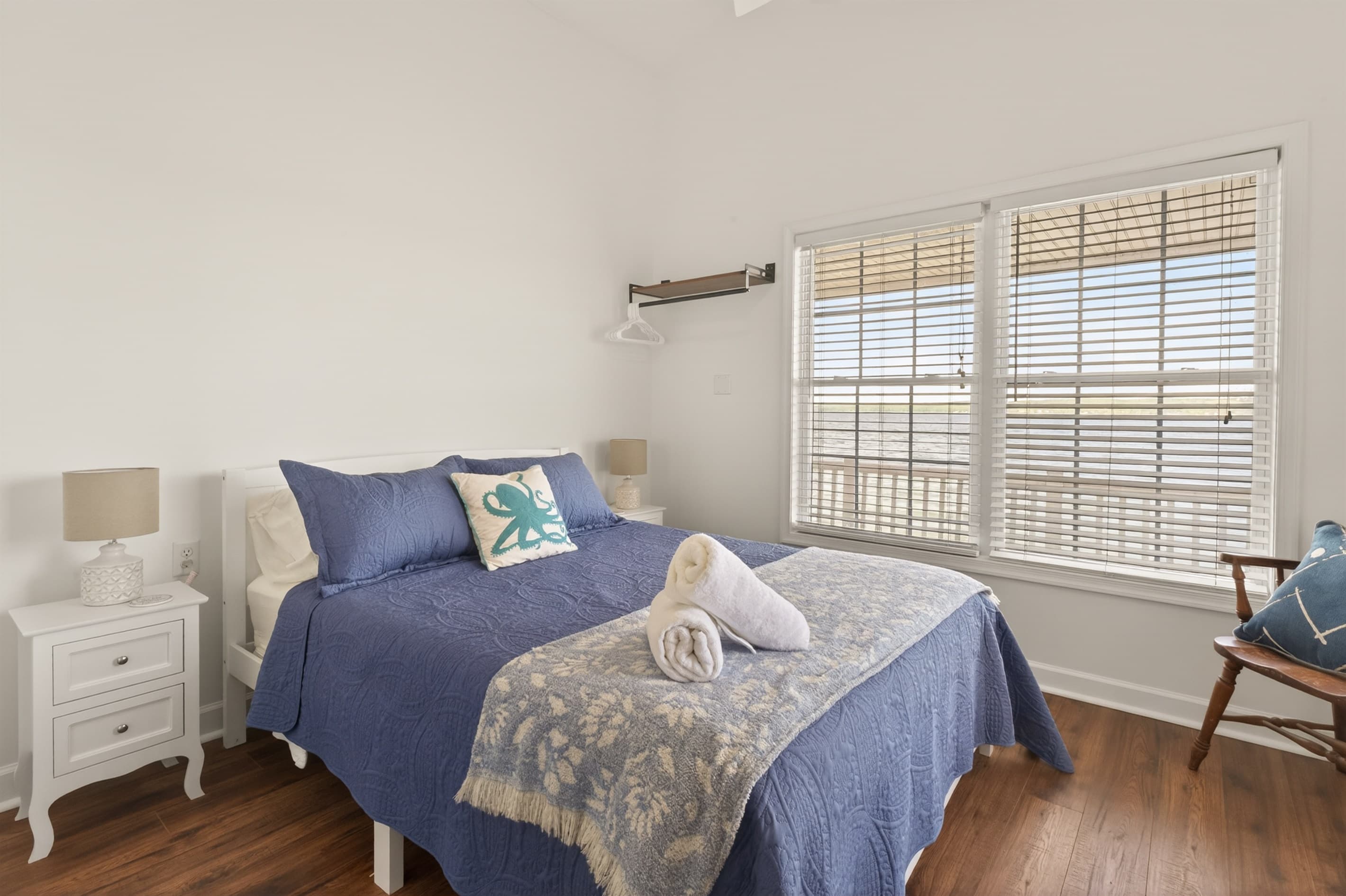 Bedroom with blue bedding and window seating