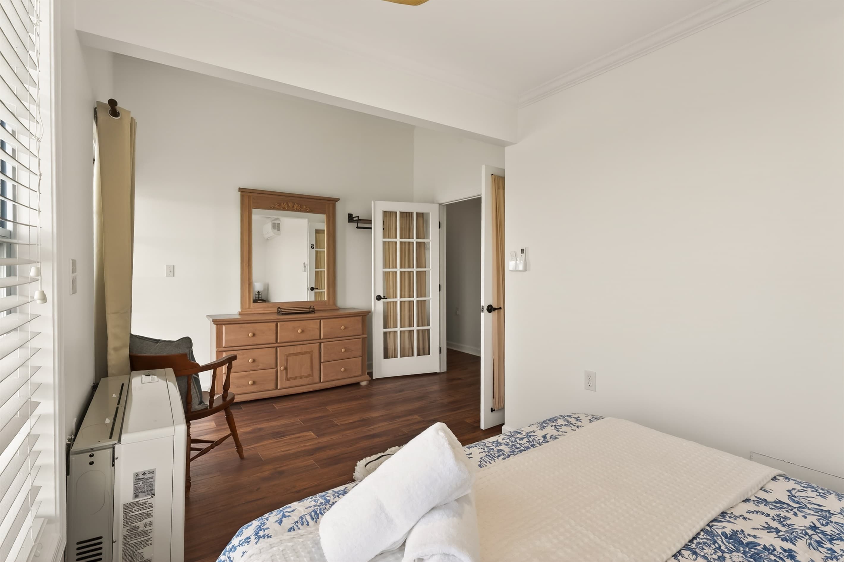 Bedroom dresser beside French doors