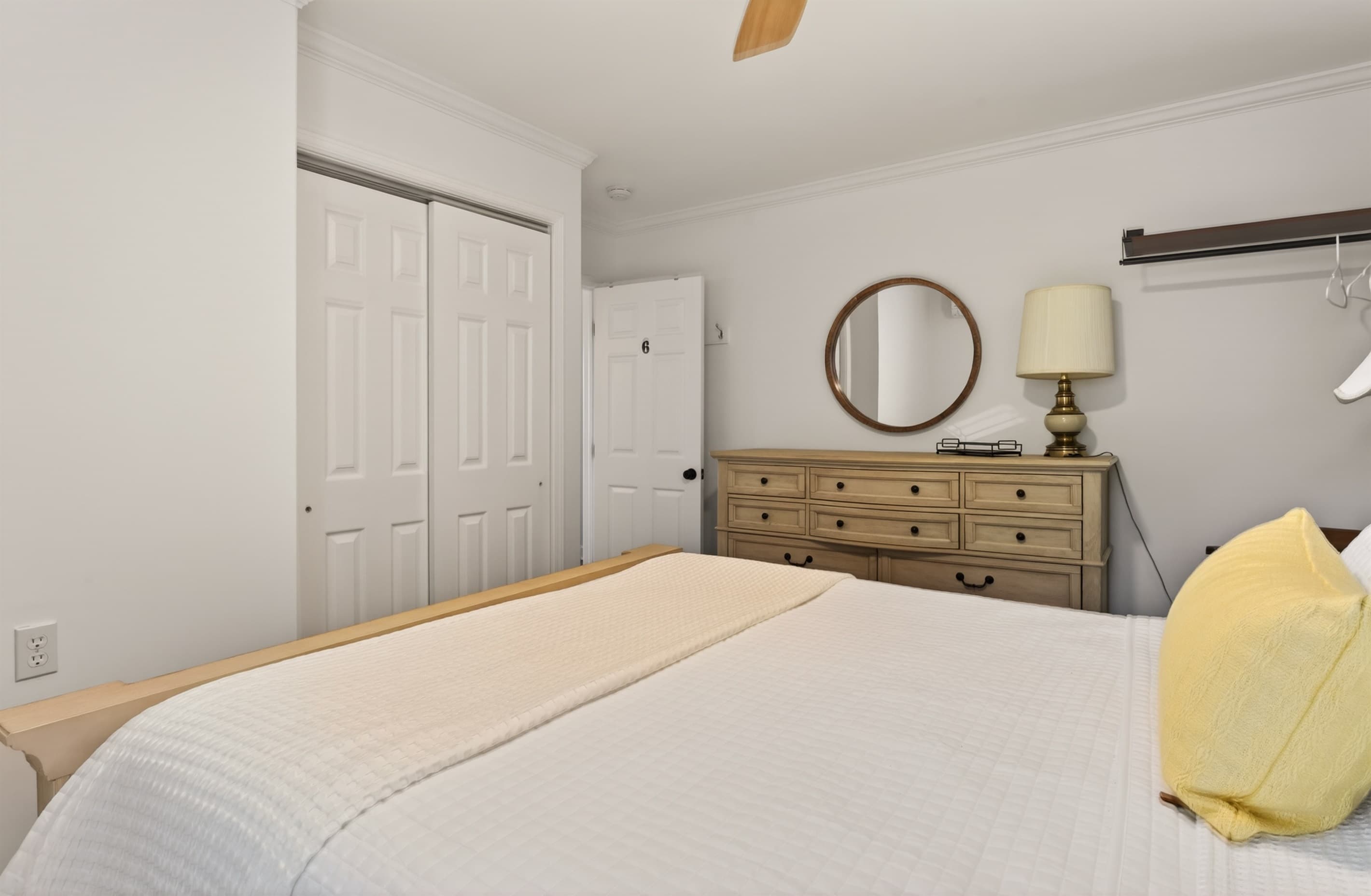 Bedroom with large dresser and closet