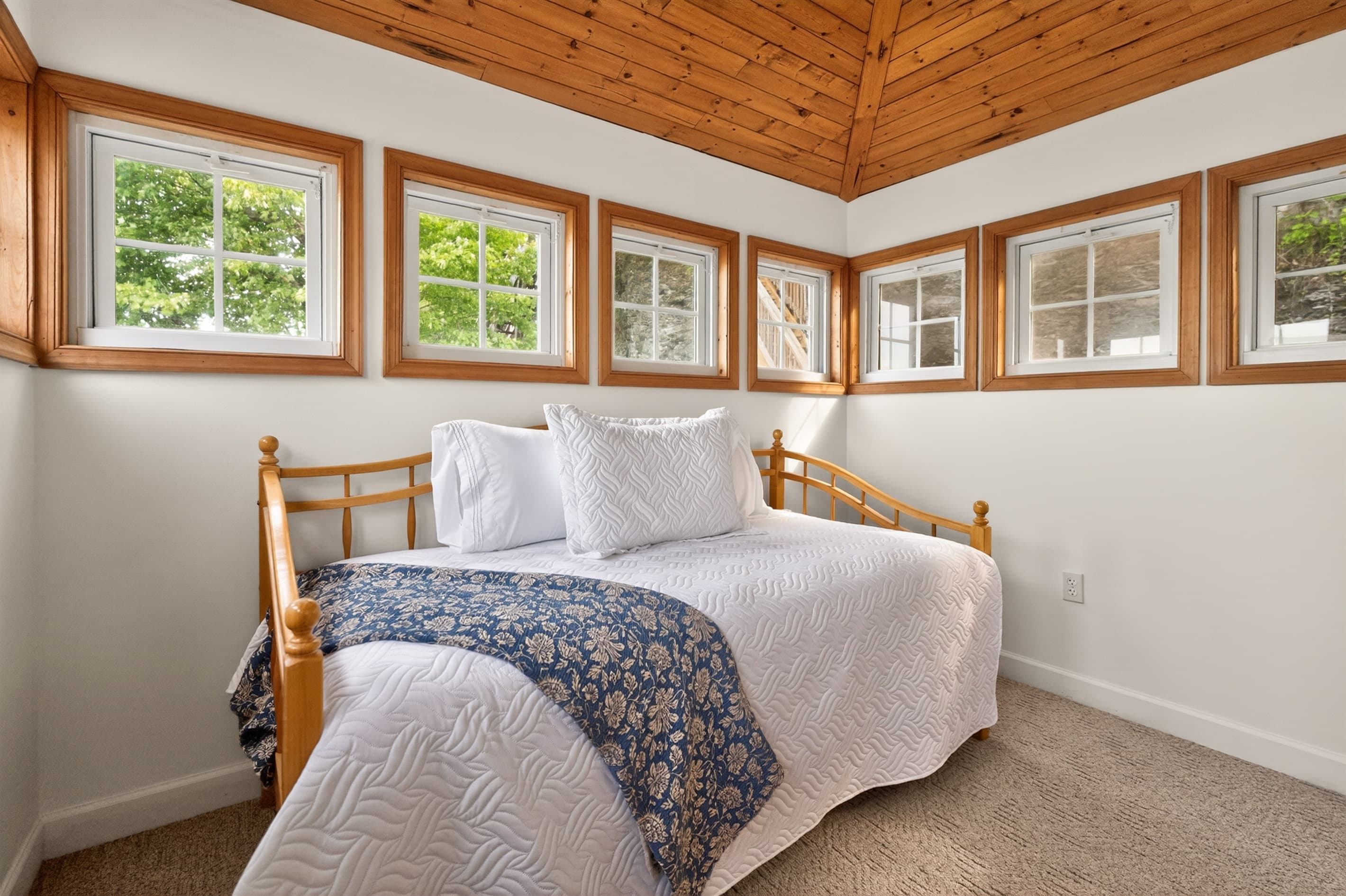 Sunroom bedroom with wraparound windows