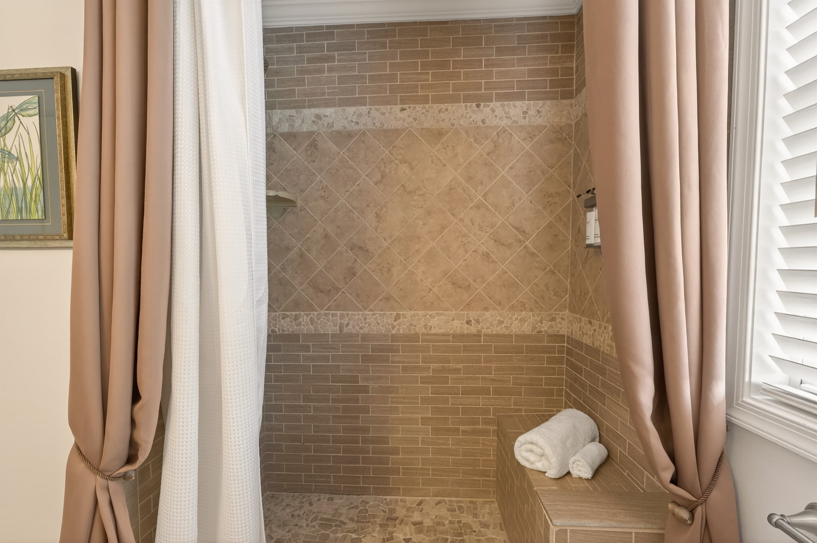 Walk-in tiled shower with curtain