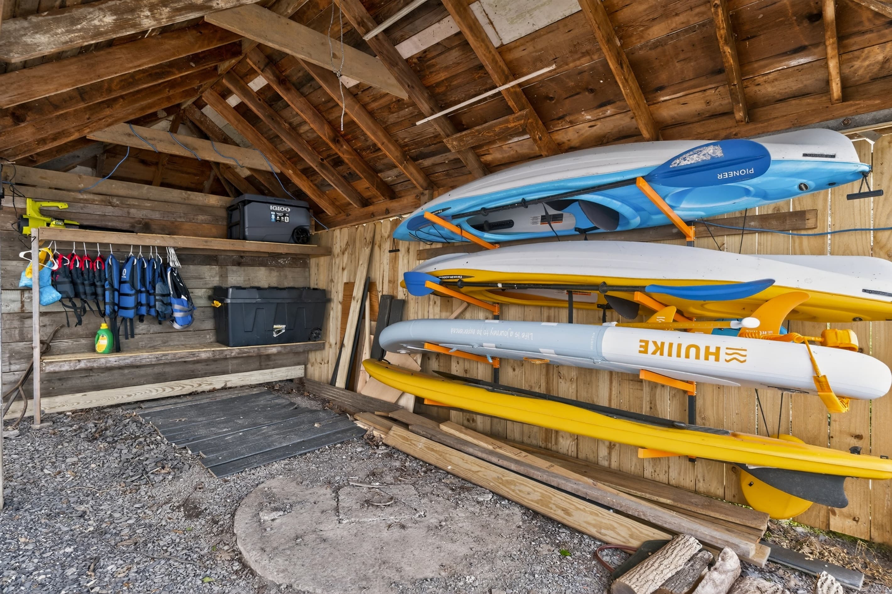 Covered kayak storage beside the home
