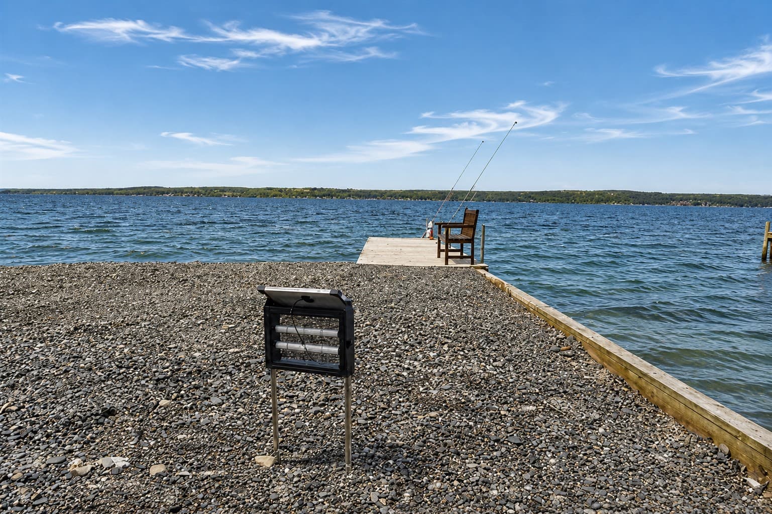 Pebbled shoreline with private dock