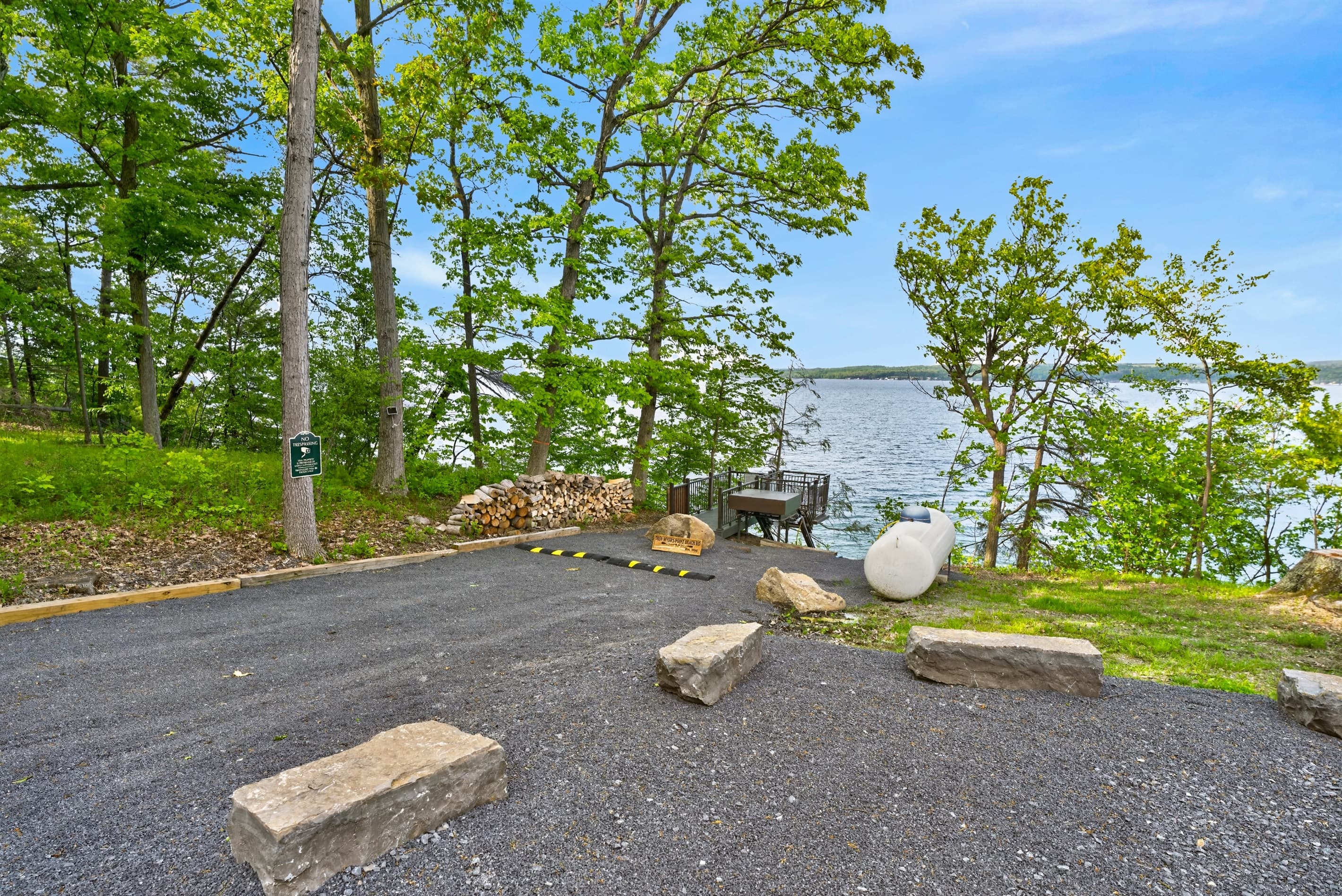 Lakeside parking area beneath mature trees