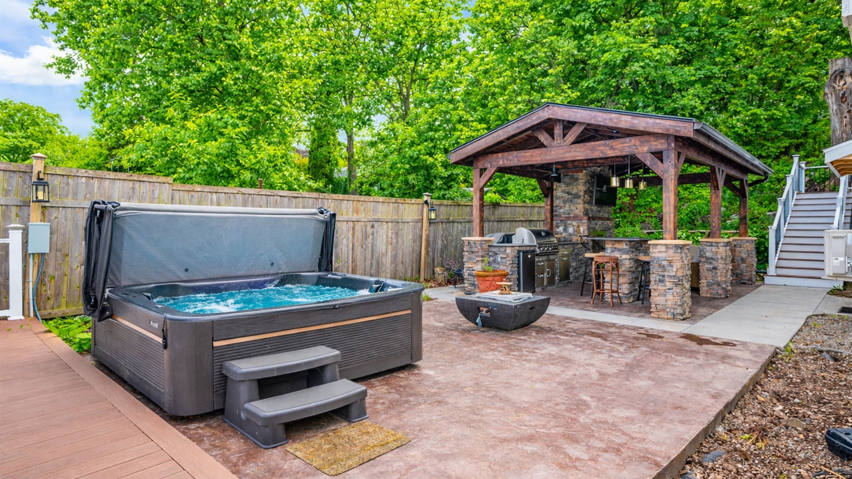 Covered outdoor kitchen beside the hot tub