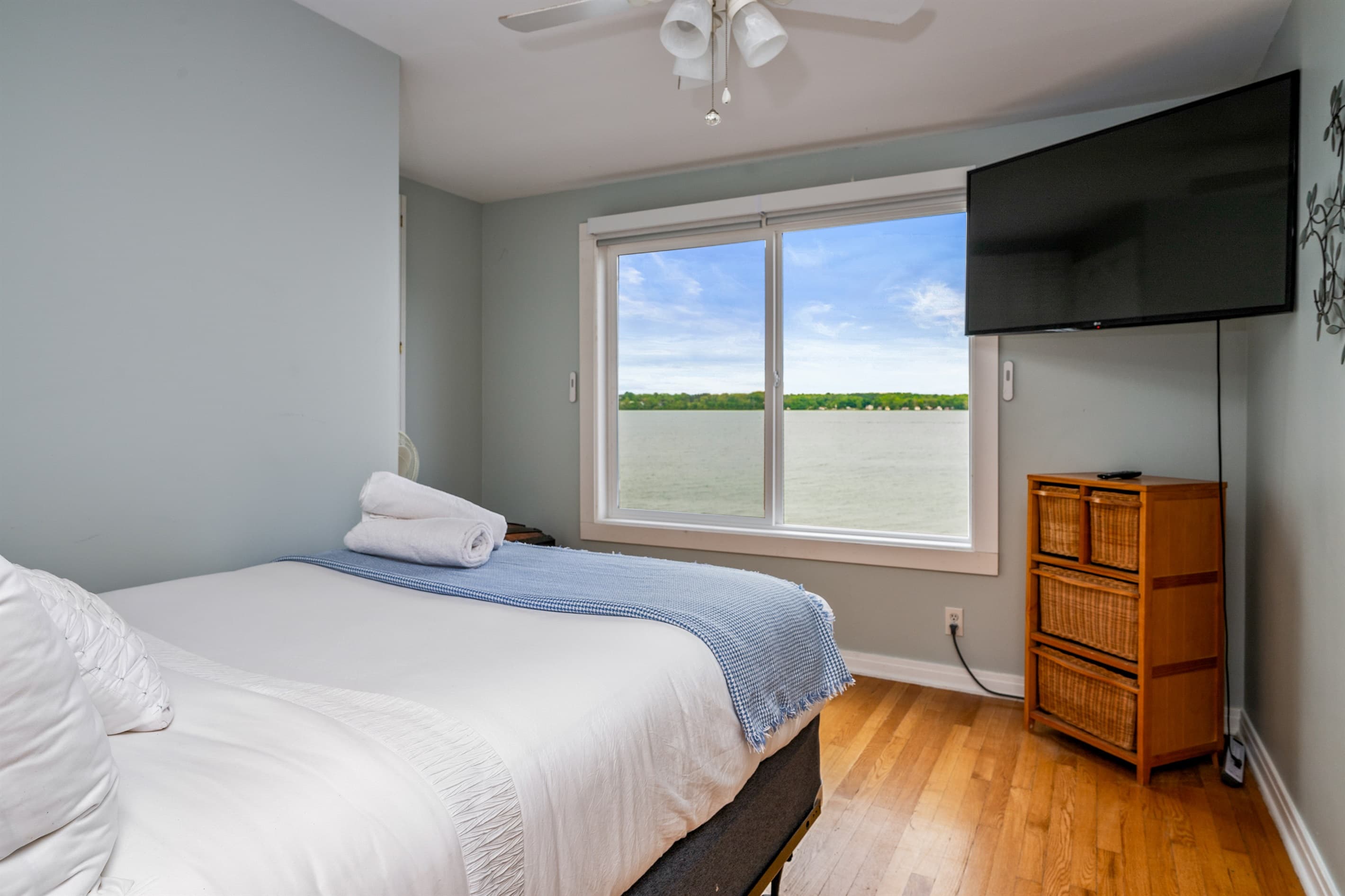 Bedroom with lake-facing window and television