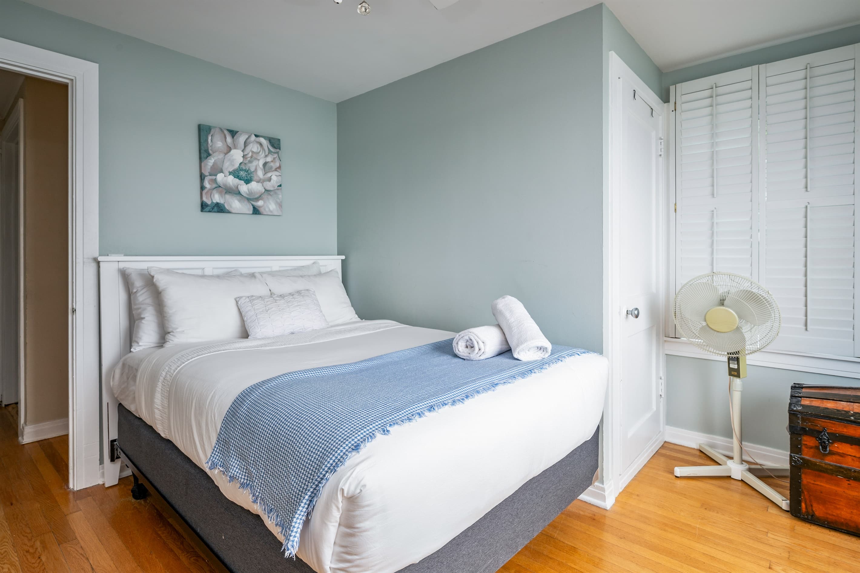 Blue bedroom with white wooded bed