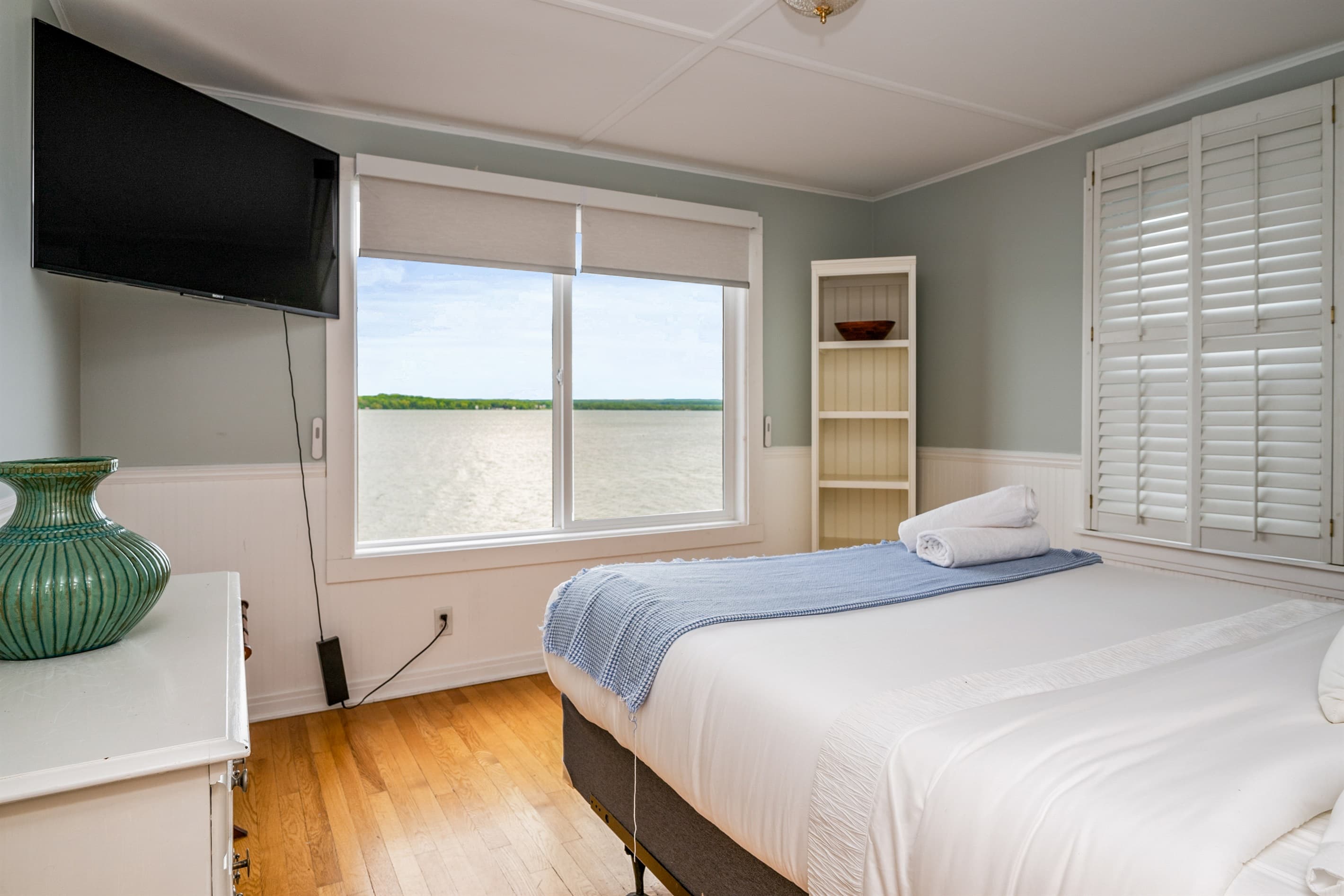 Bedroom with two windows and built-in shelves