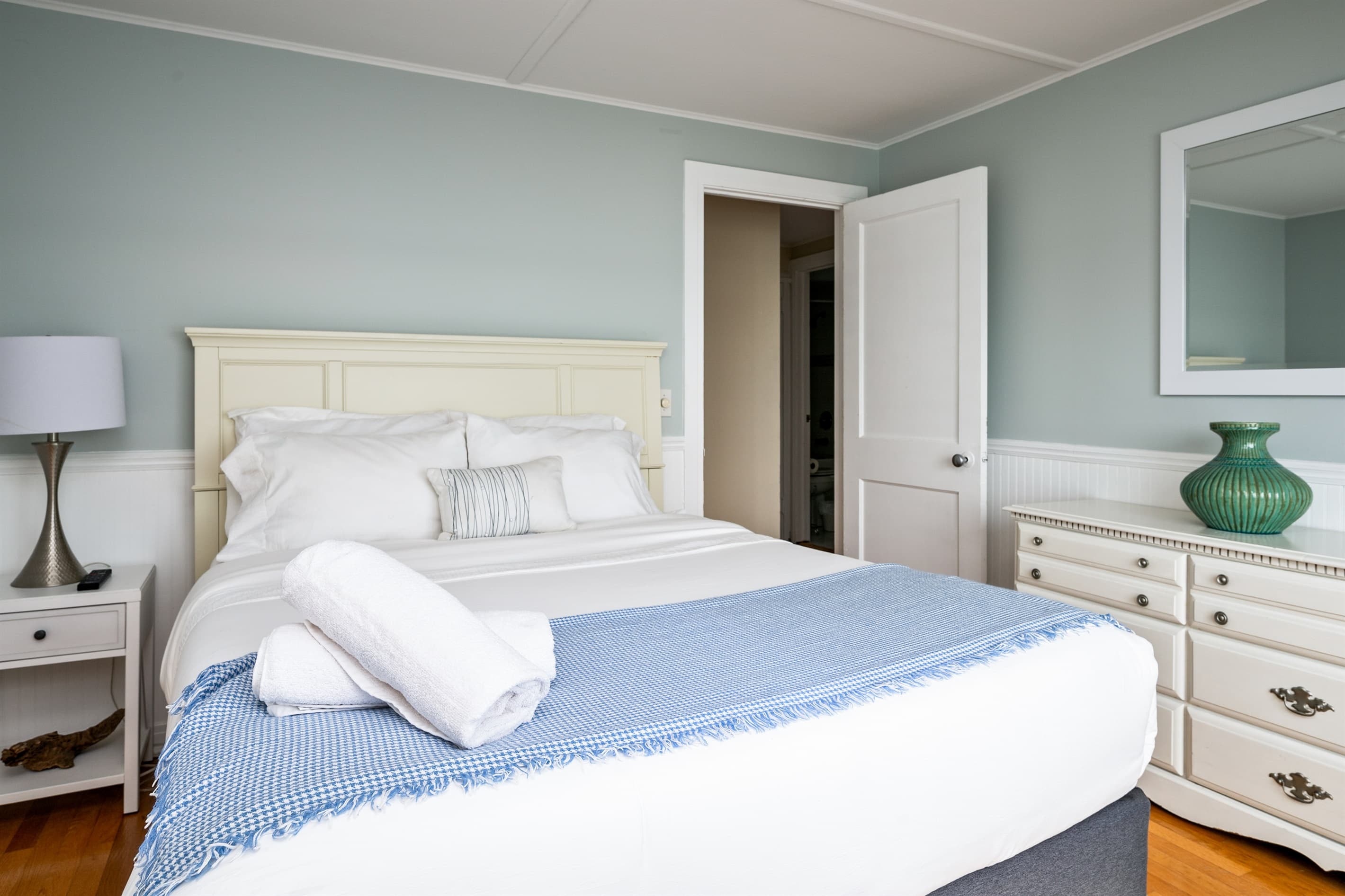 Guest bedroom with dresser and mirror