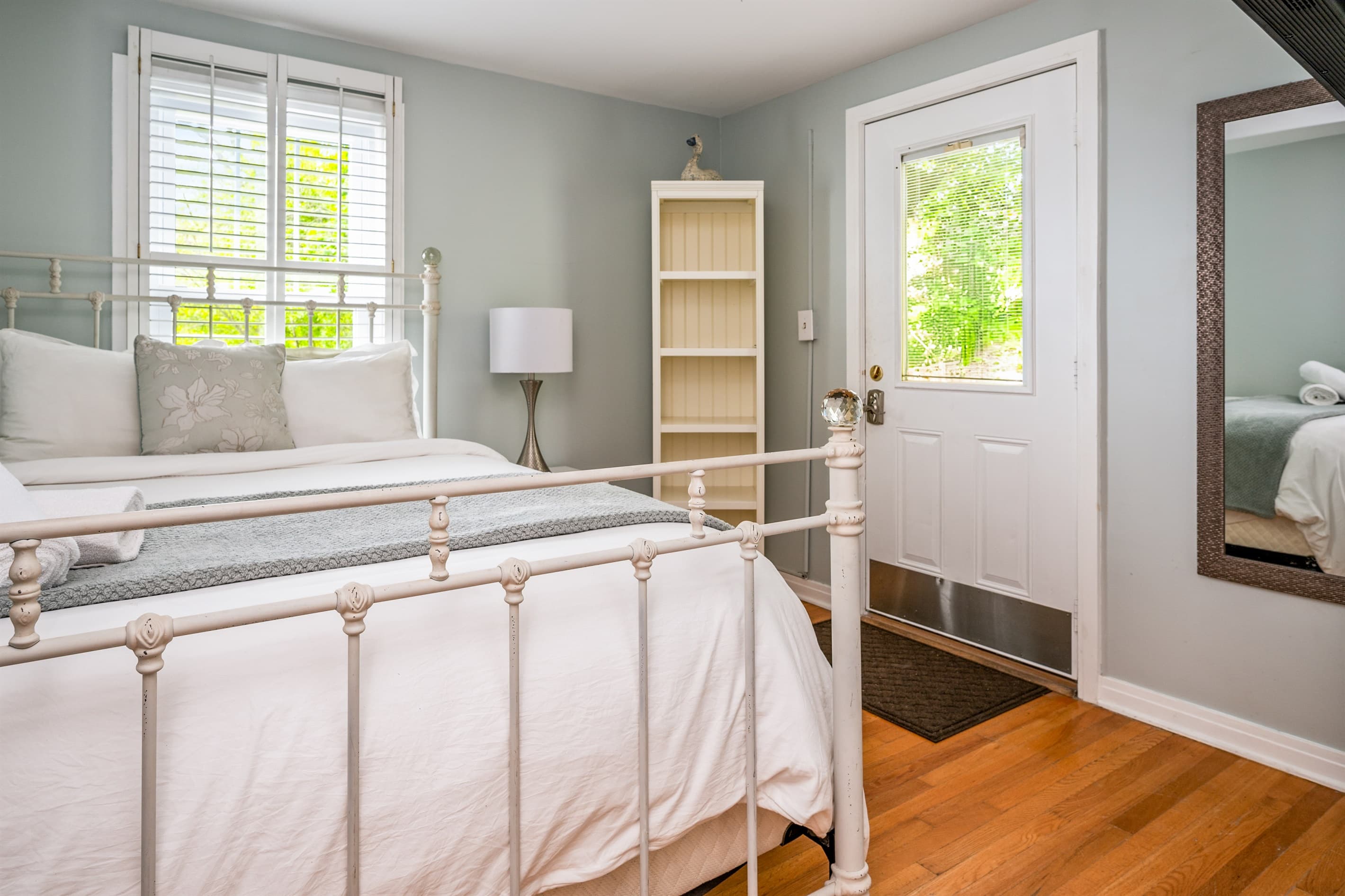 Bedroom with full length mirror and bookcase