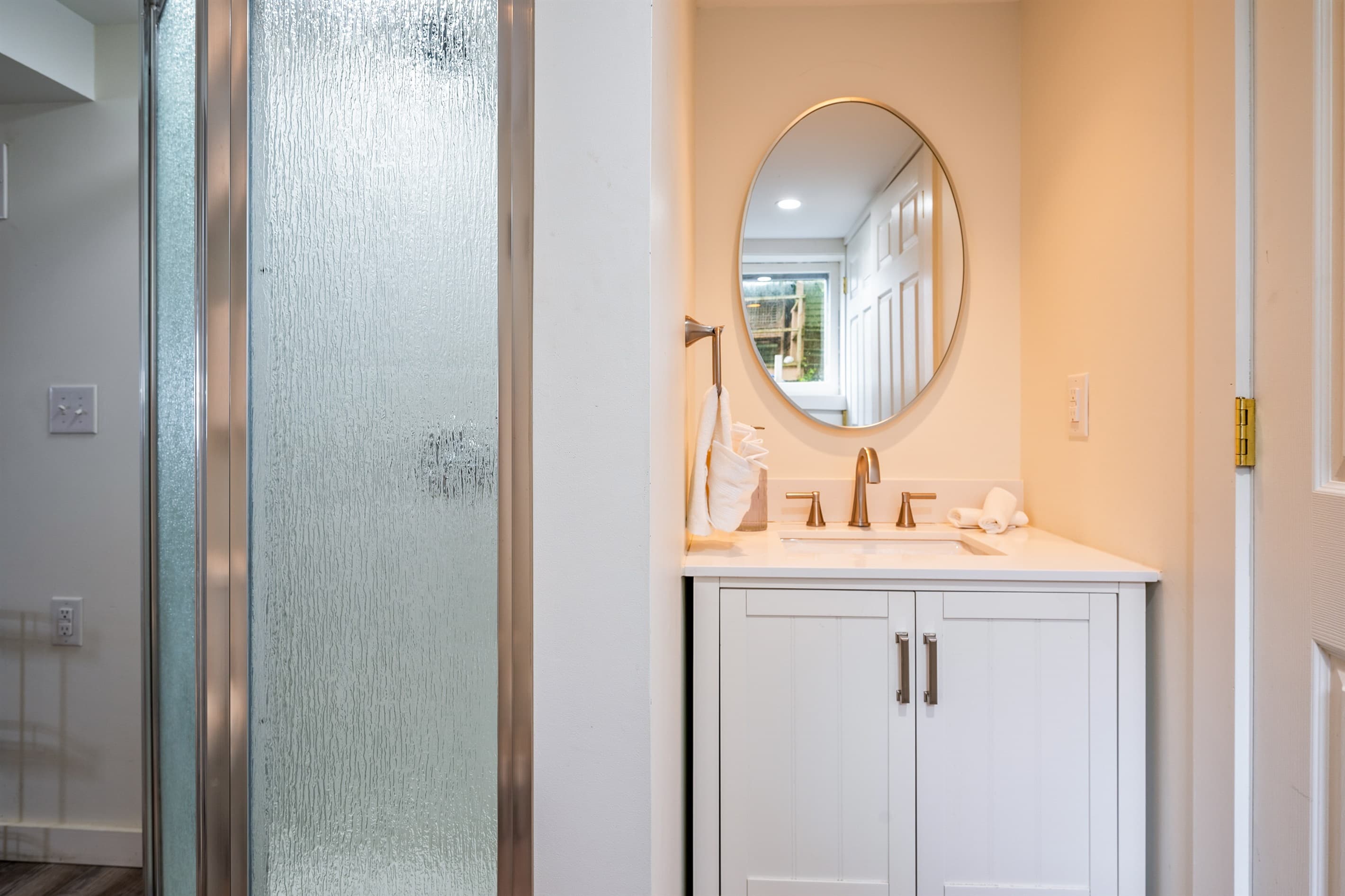 Vanity beside glass-enclosed shower