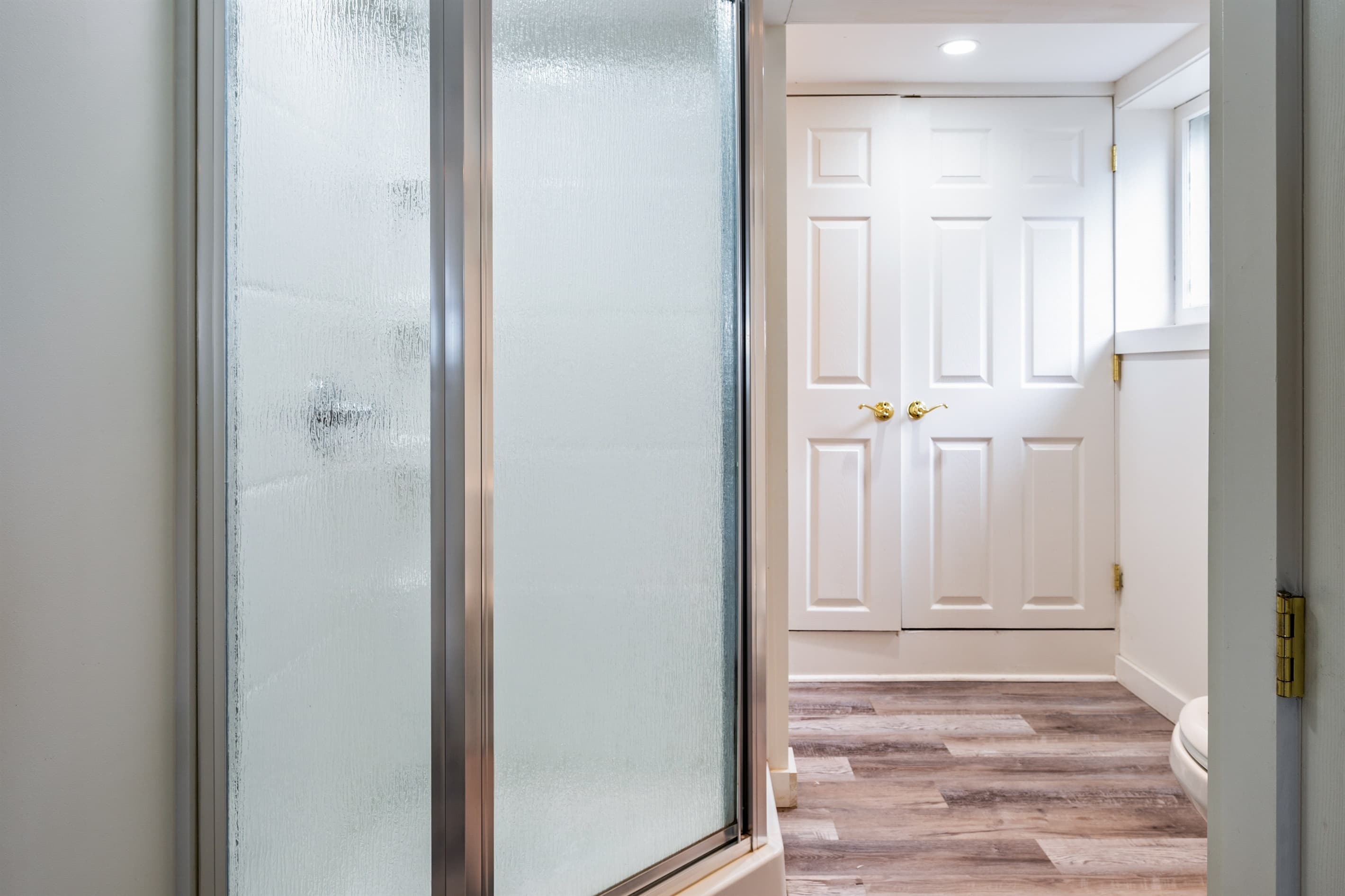 Full bathroom with glass-enclosed shower