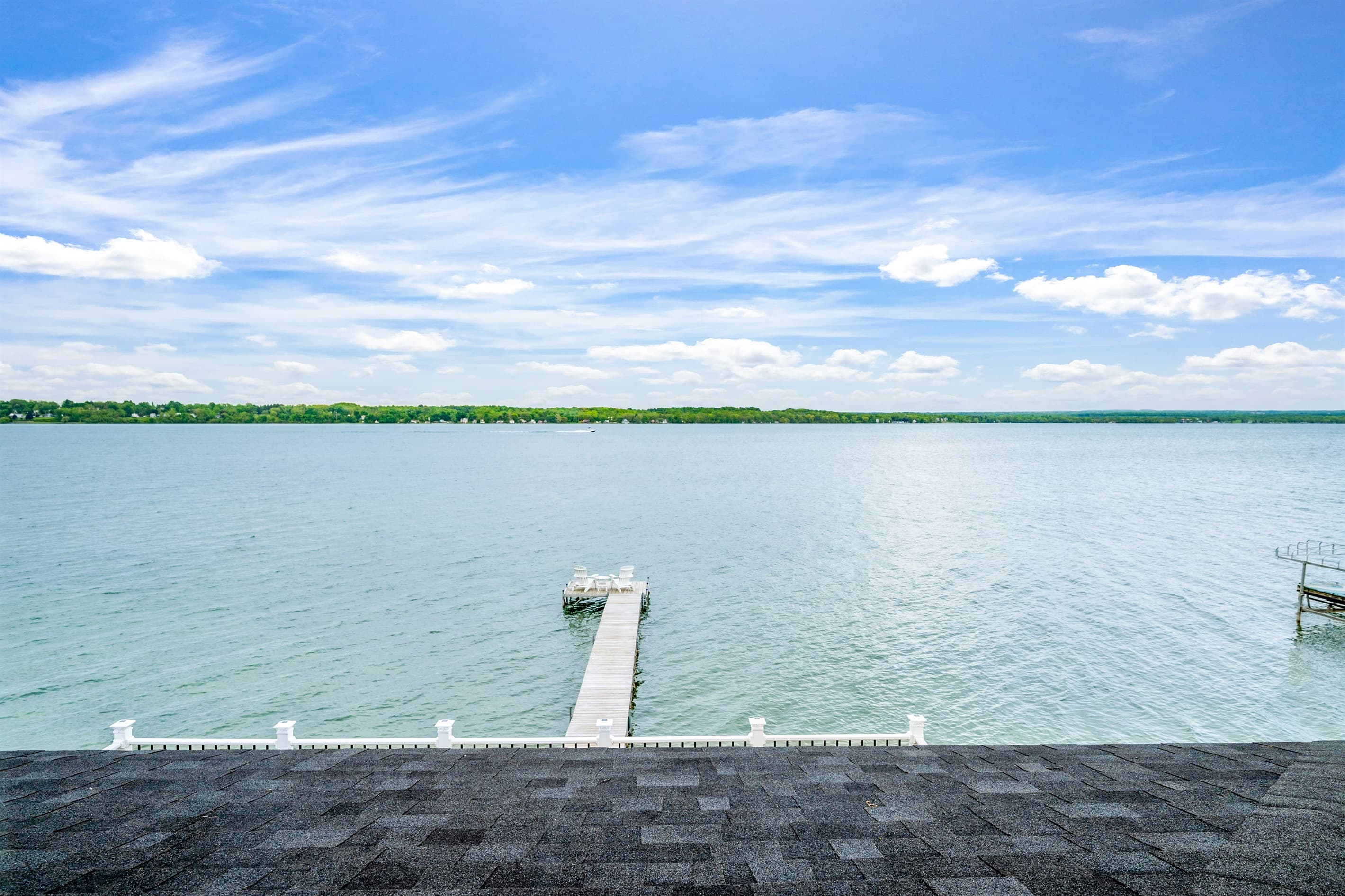 Panoramic lake view beneath scattered clouds