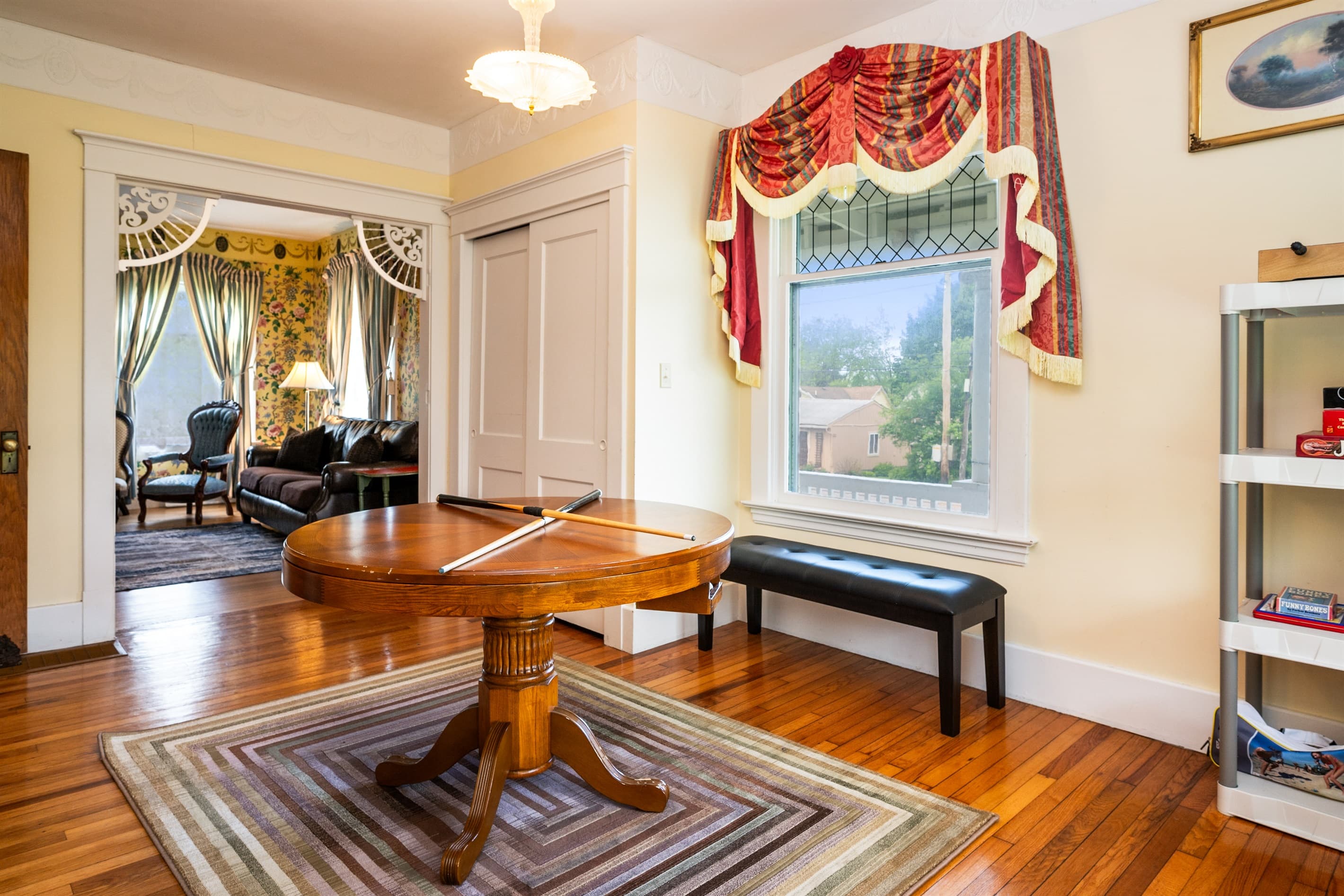 Room with convertible game table and window bench seating