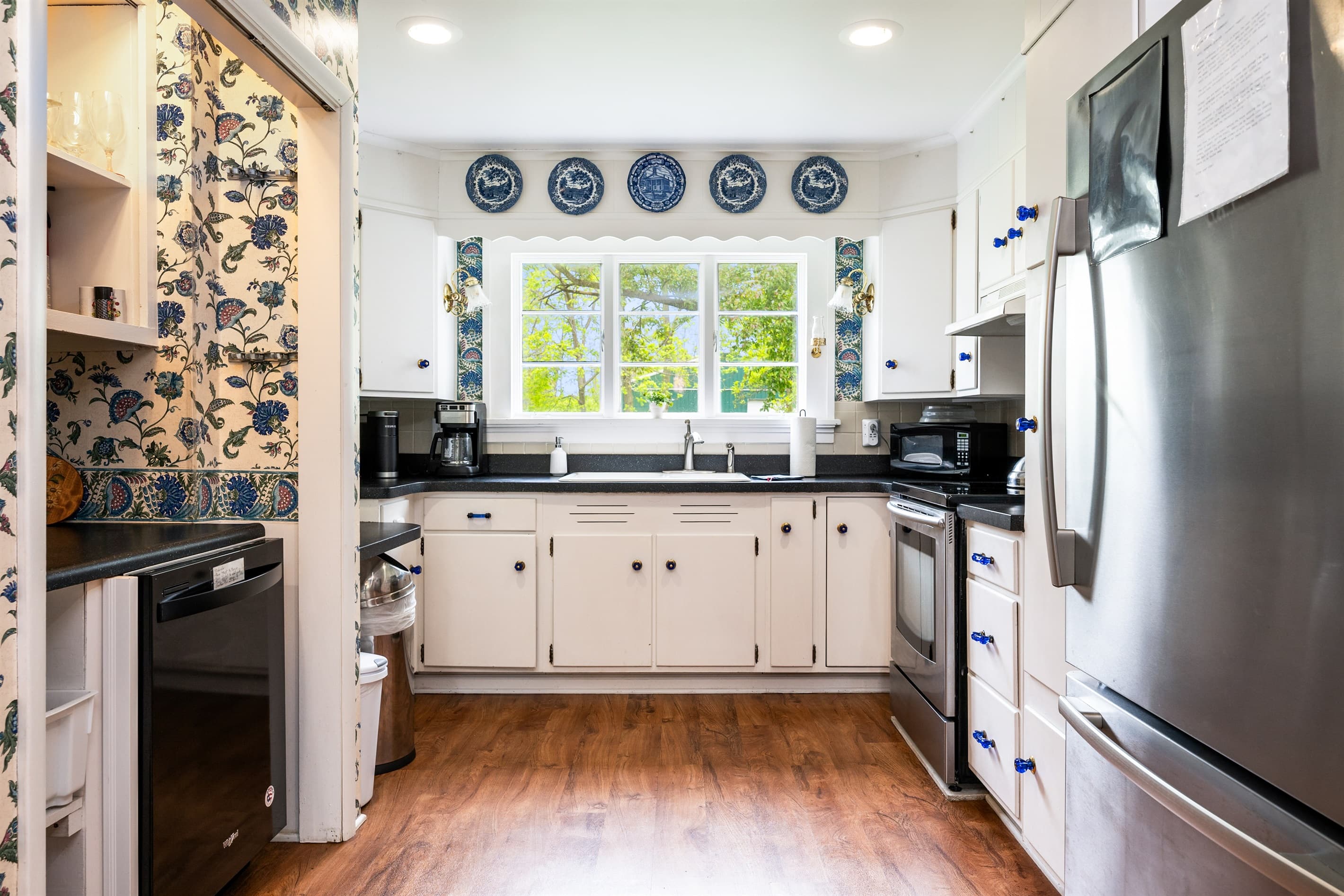 Kitchen with stainless appliances and patterned backsplash