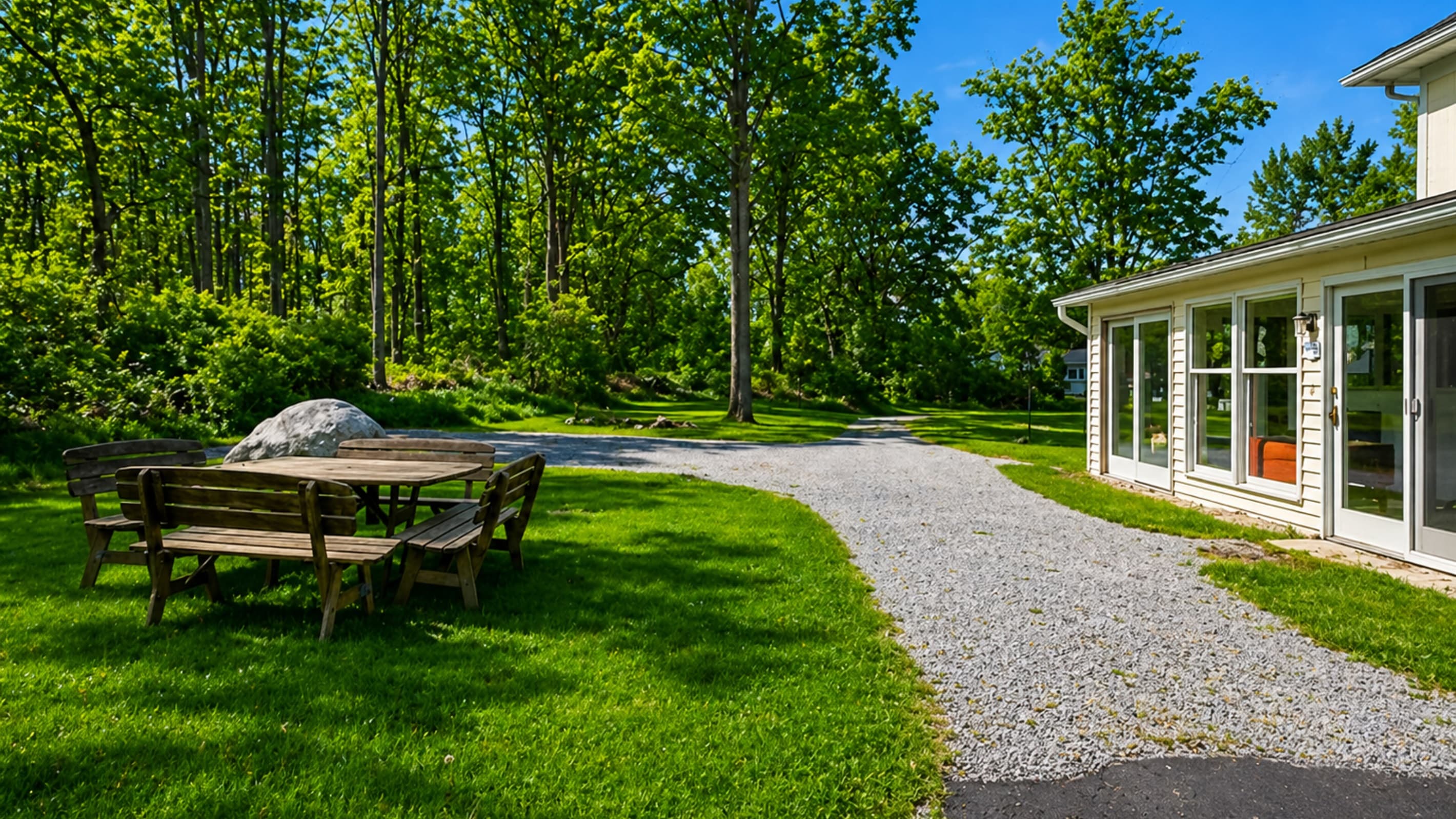 Gravel driveway bordered by trees