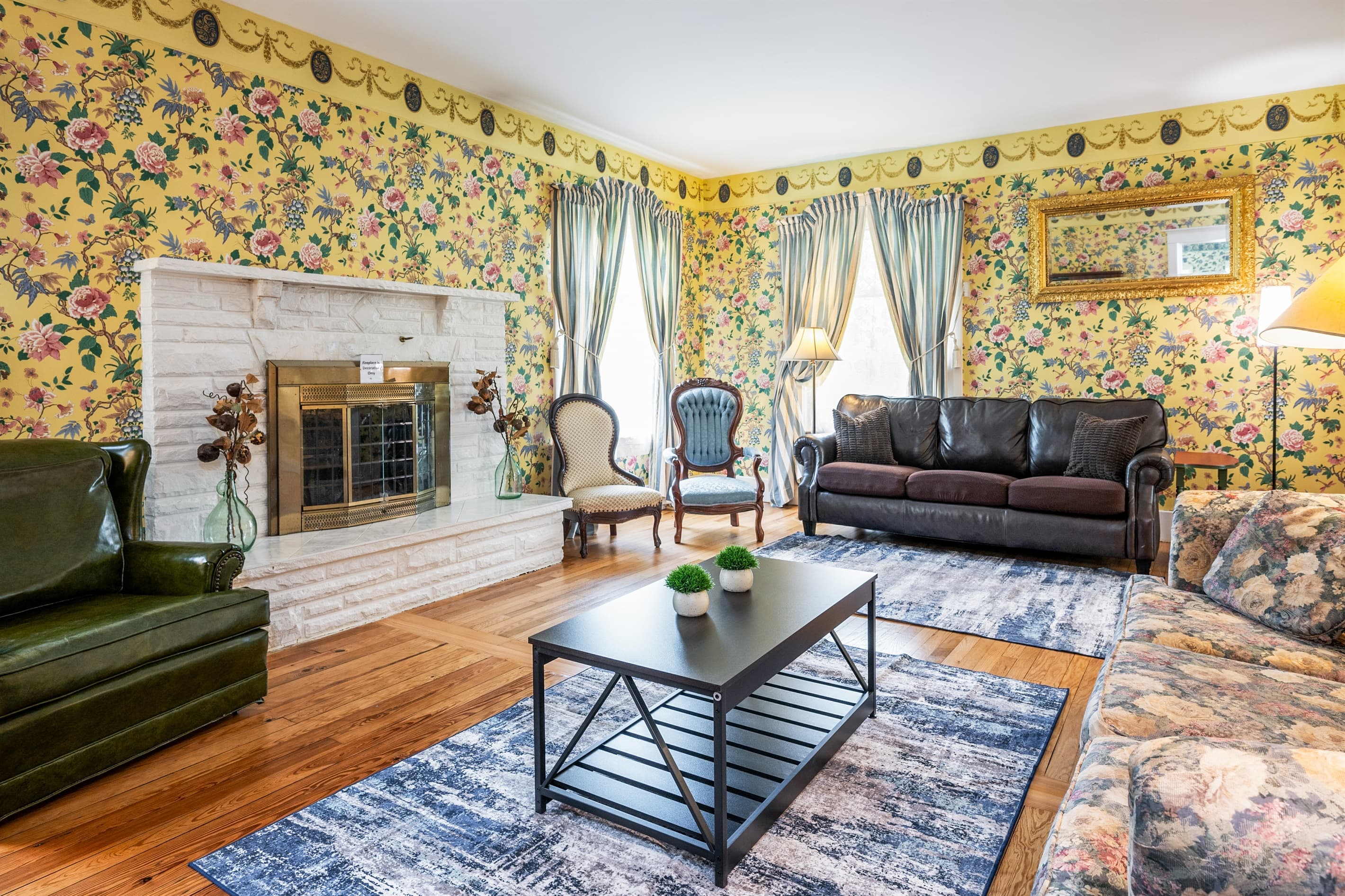 Living room with brick fireplace and windows