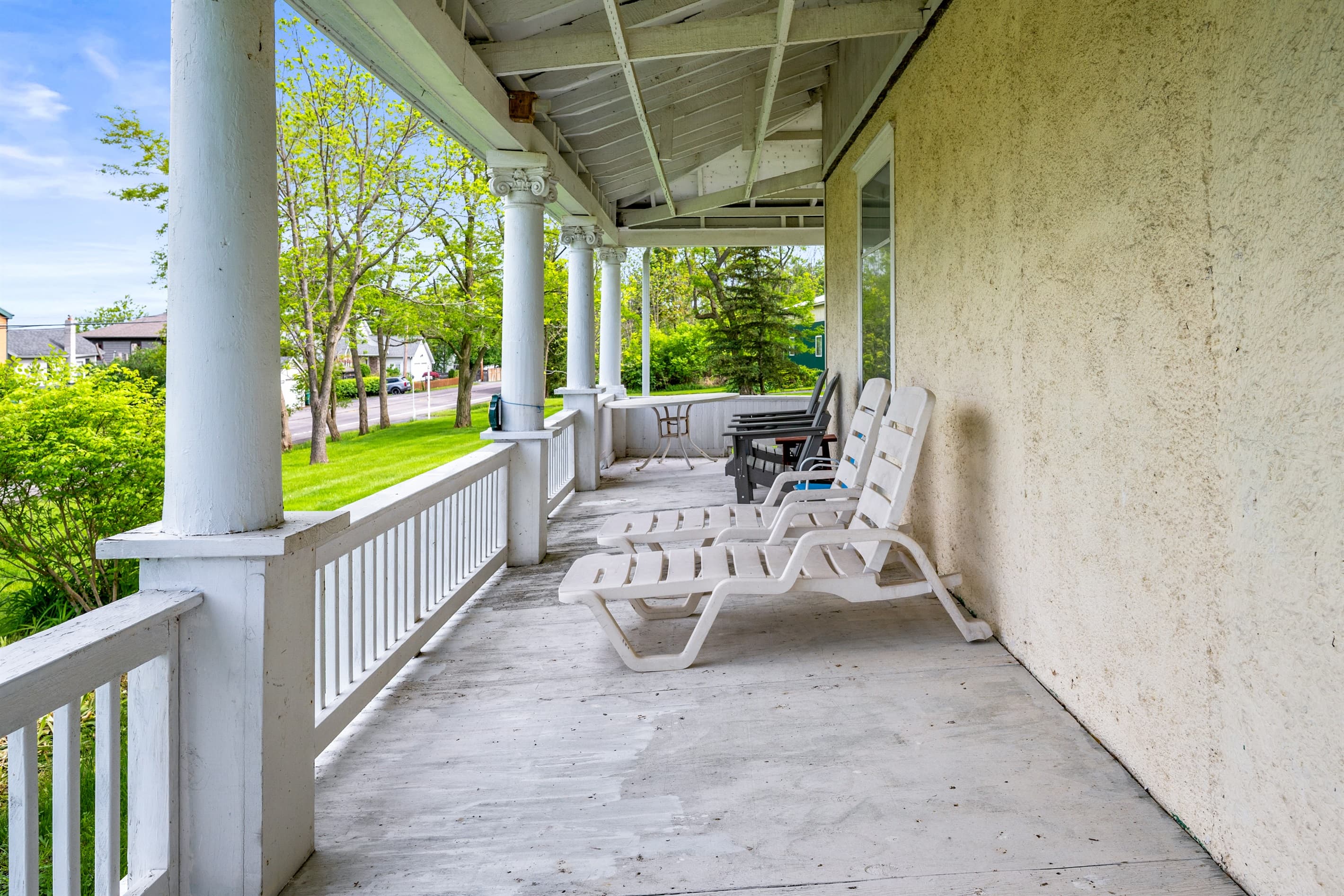 Plastic lounge chairs along covered porch