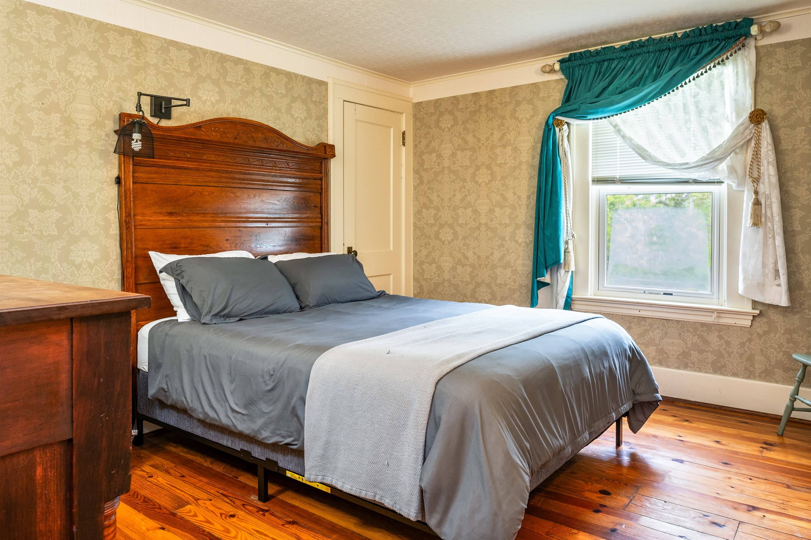 Bedroom with wooden headboard and window