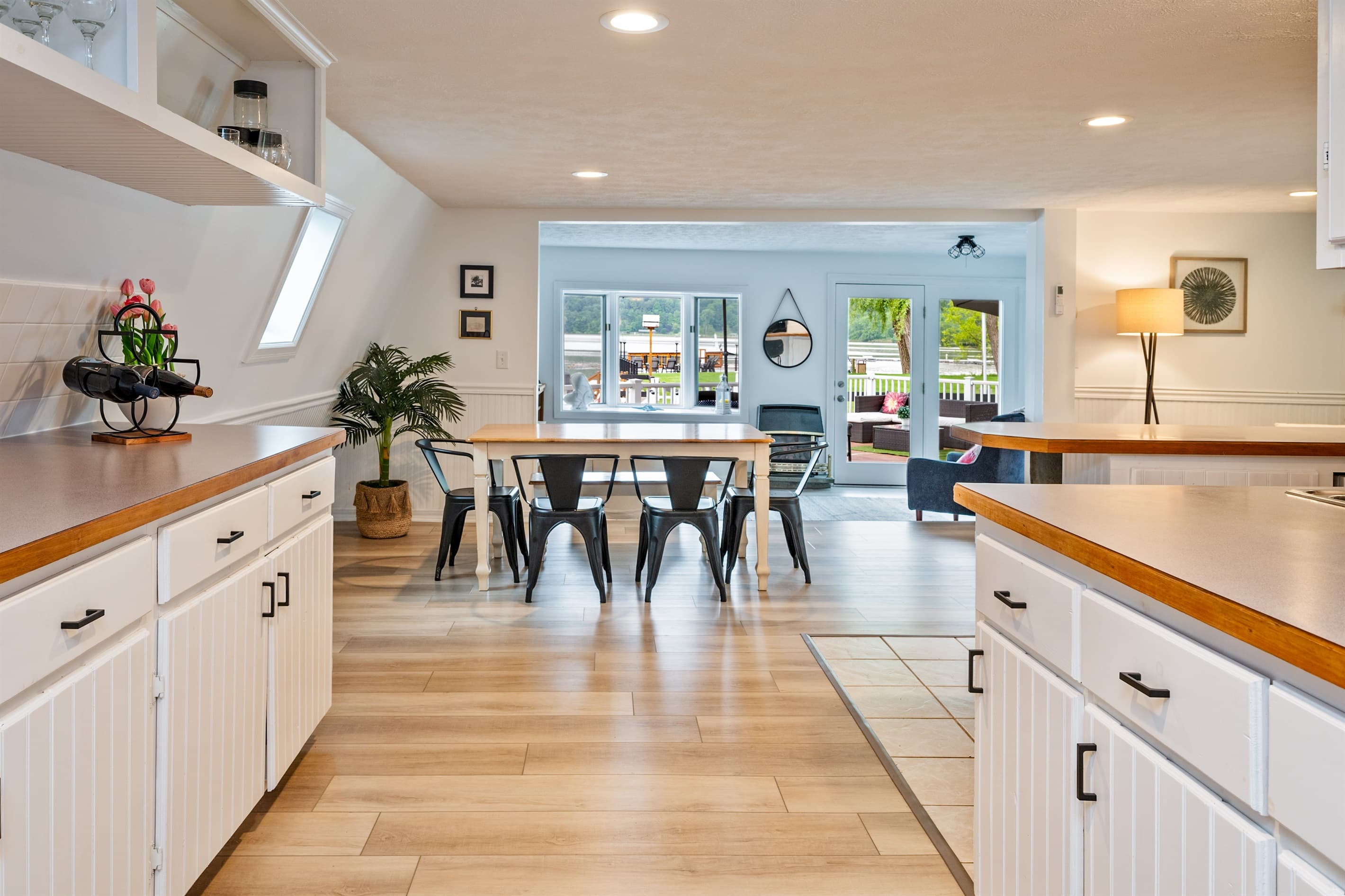 Wooden kitchen counter with white drawers and shelves