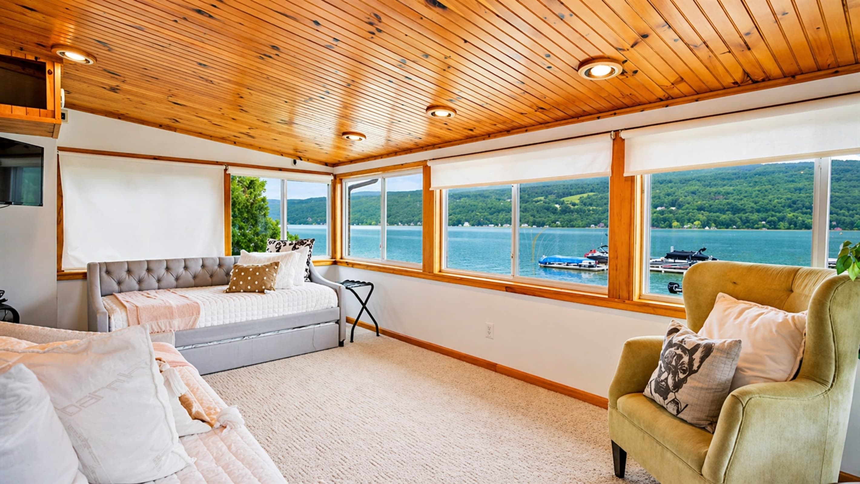 Window-lined sunroom facing the lake