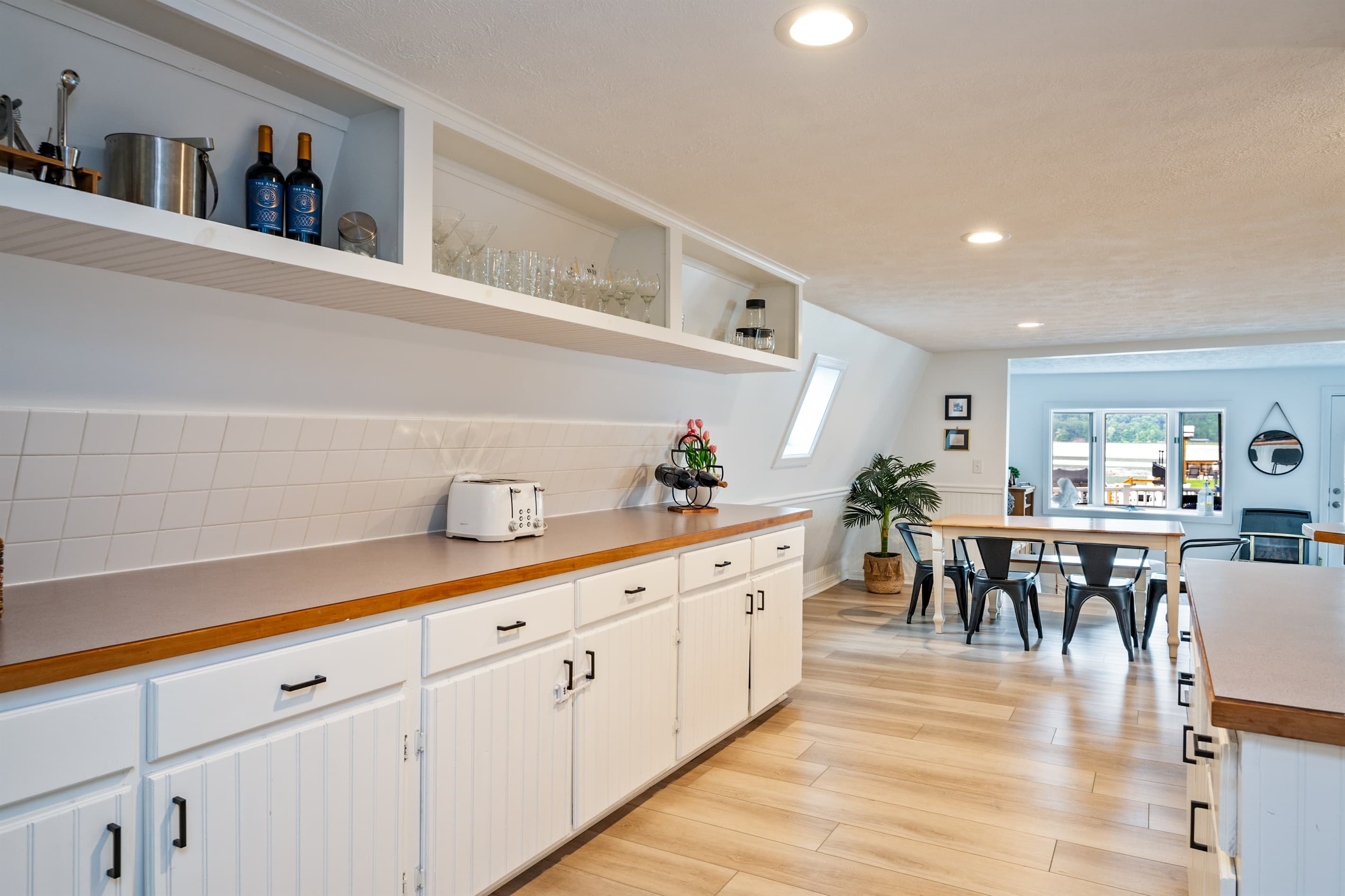 Kitchen counter with white drawers beneath shelves