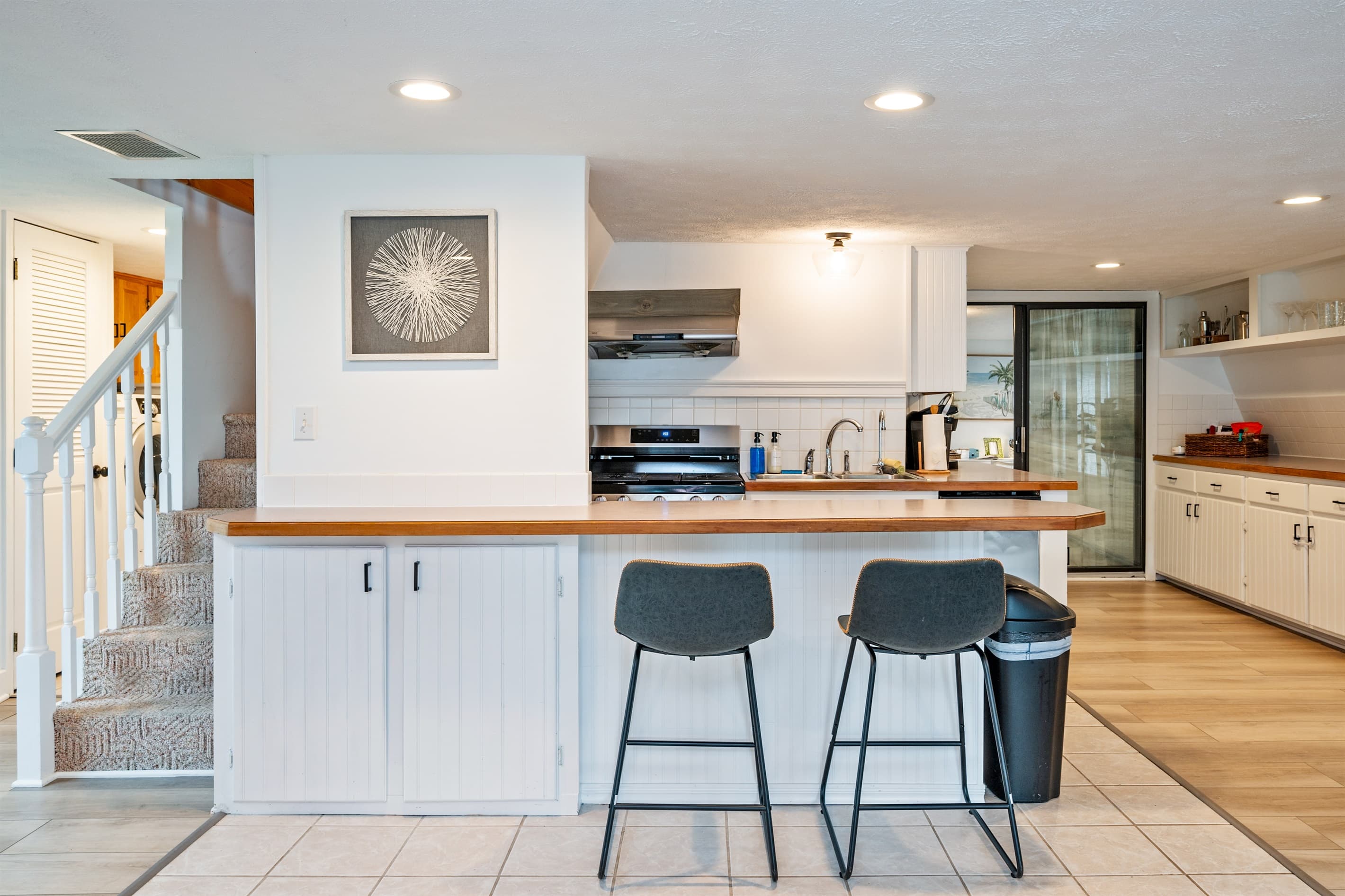 Kitchen bar seating beside the stairs 