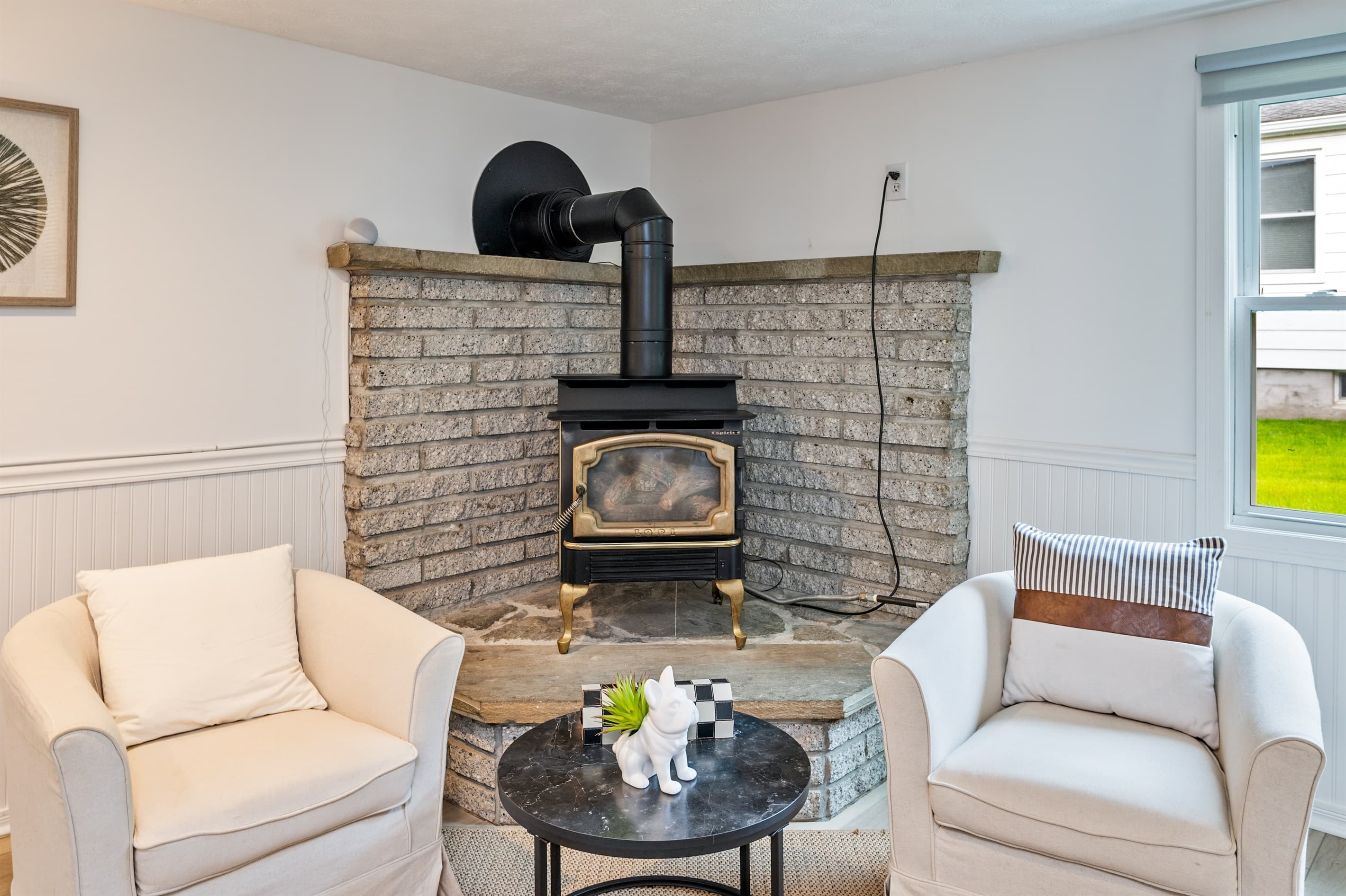 Steel fireplace against the stone wall 