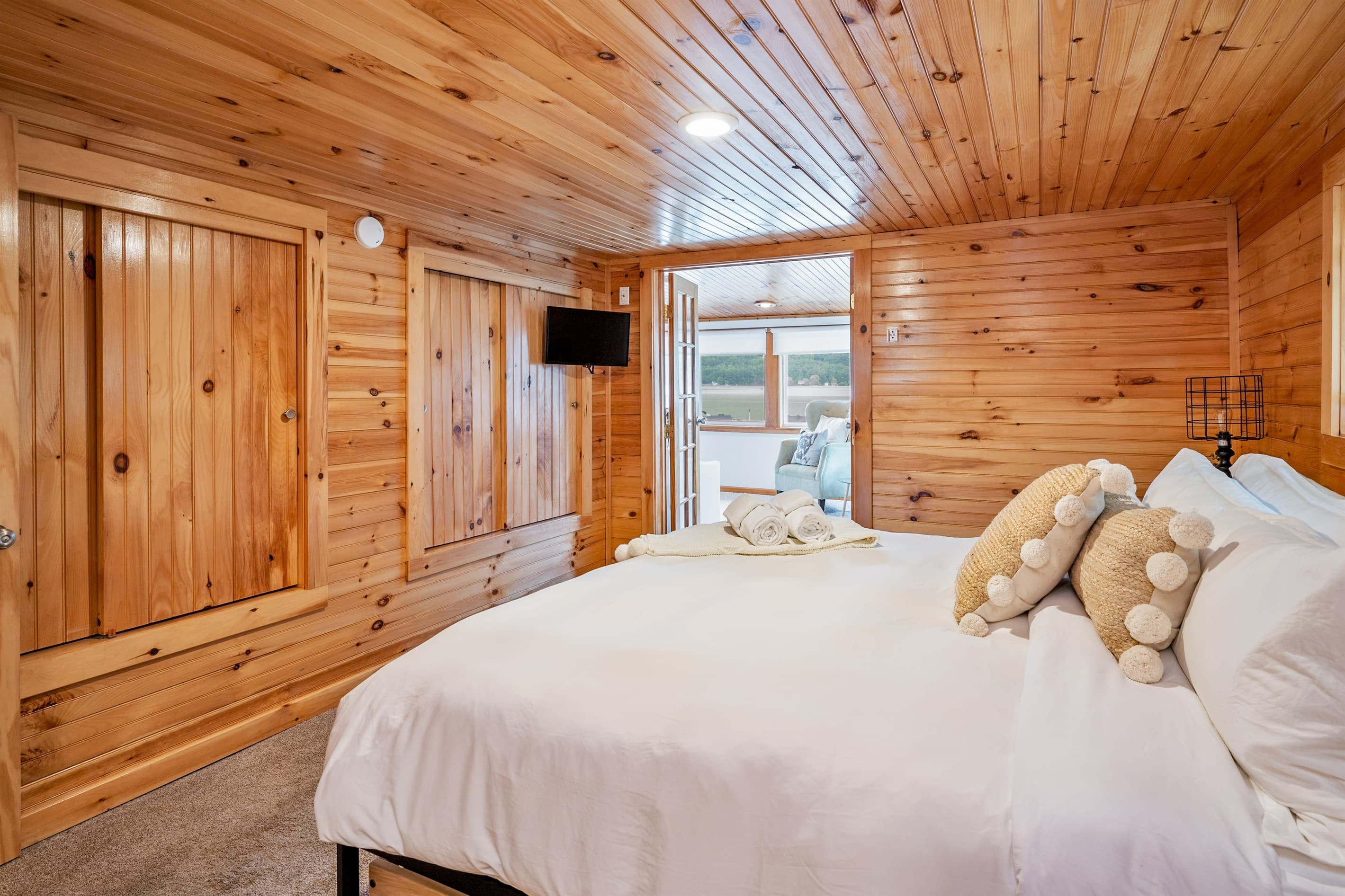 Wood paneled bedroom with television 
