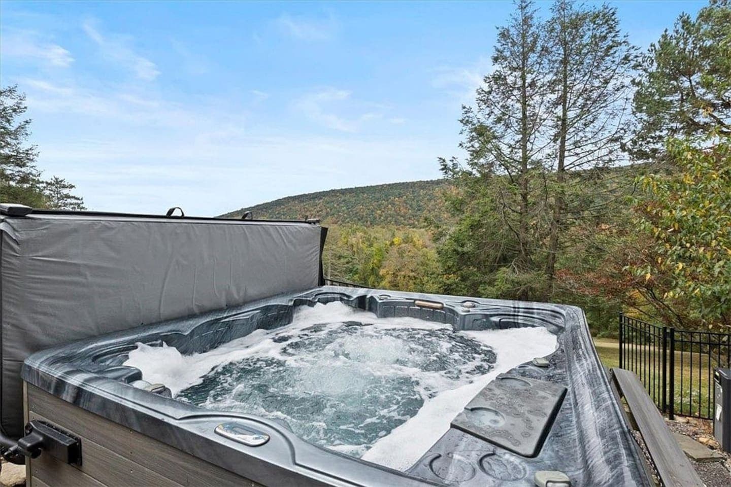 Hot tub with wooded hillside views