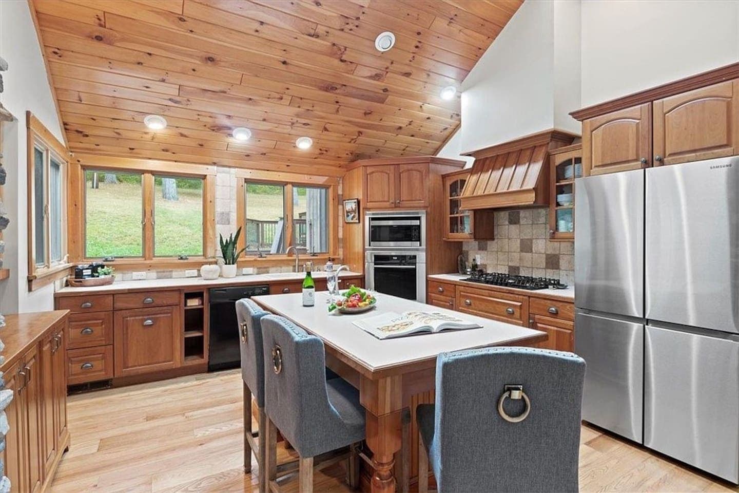 Wood-paneled kitchen with stainless steel appliances