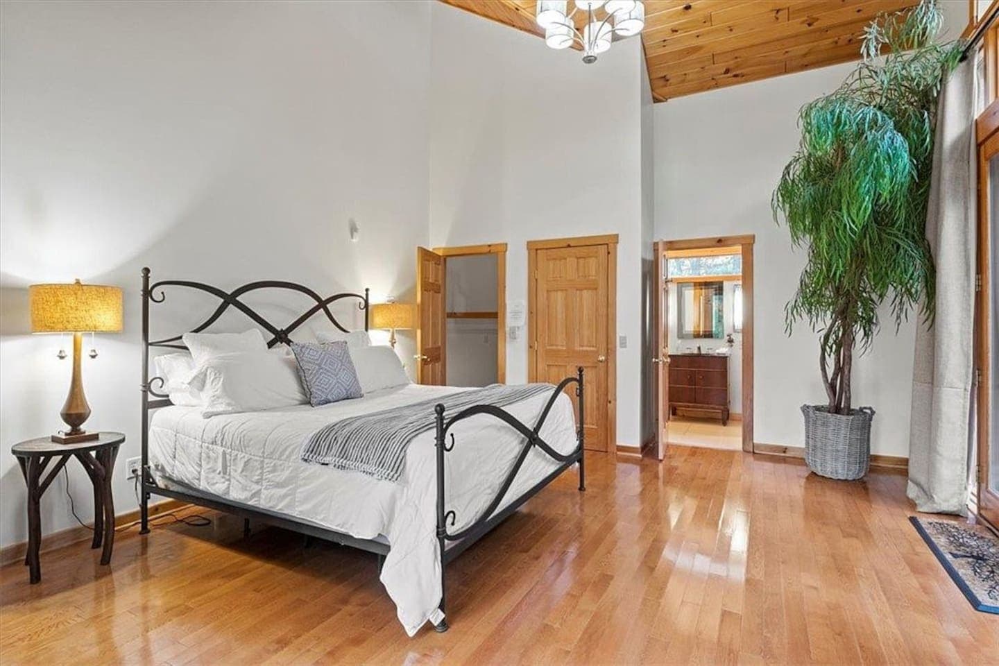 Bedroom with iron bed frame and wood accents