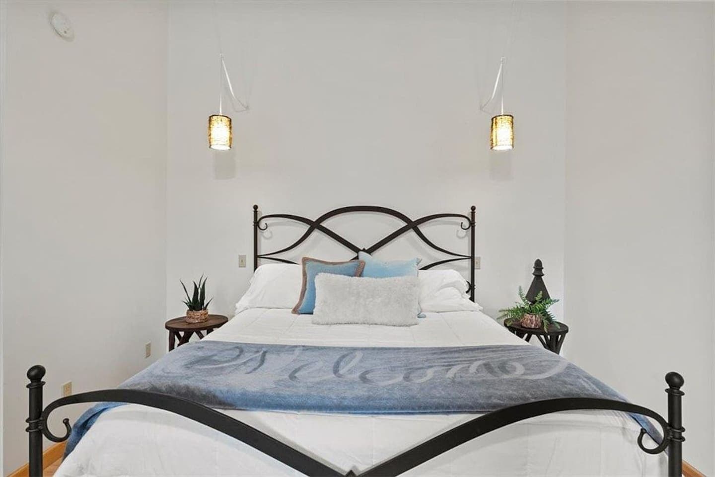 Iron-frame bed with matching hanging lights