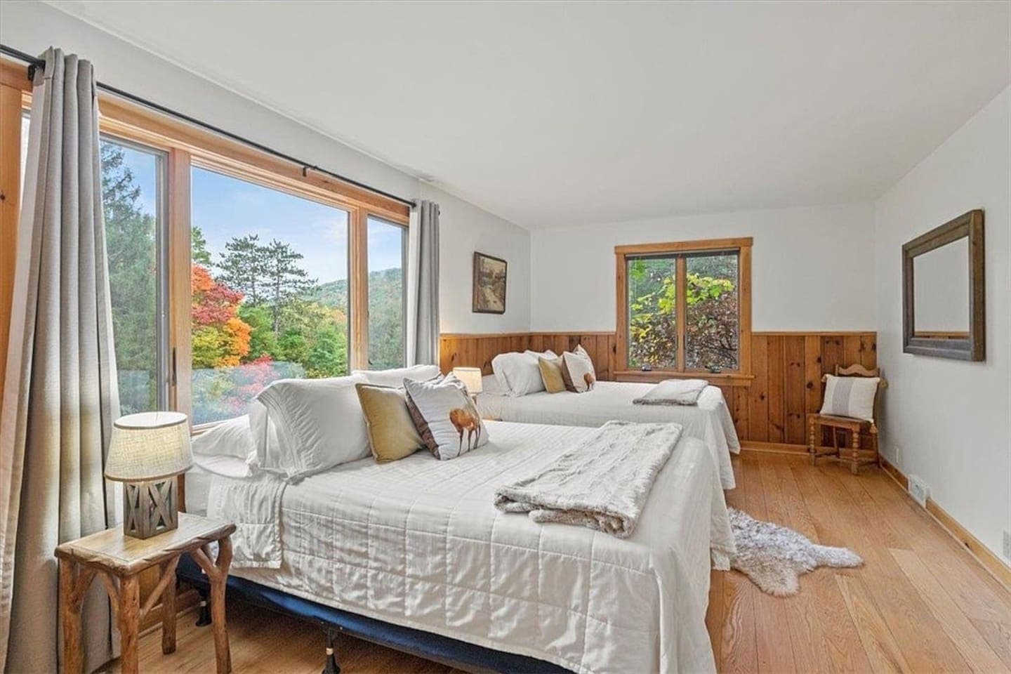 Bedroom with windows and wooden night stands