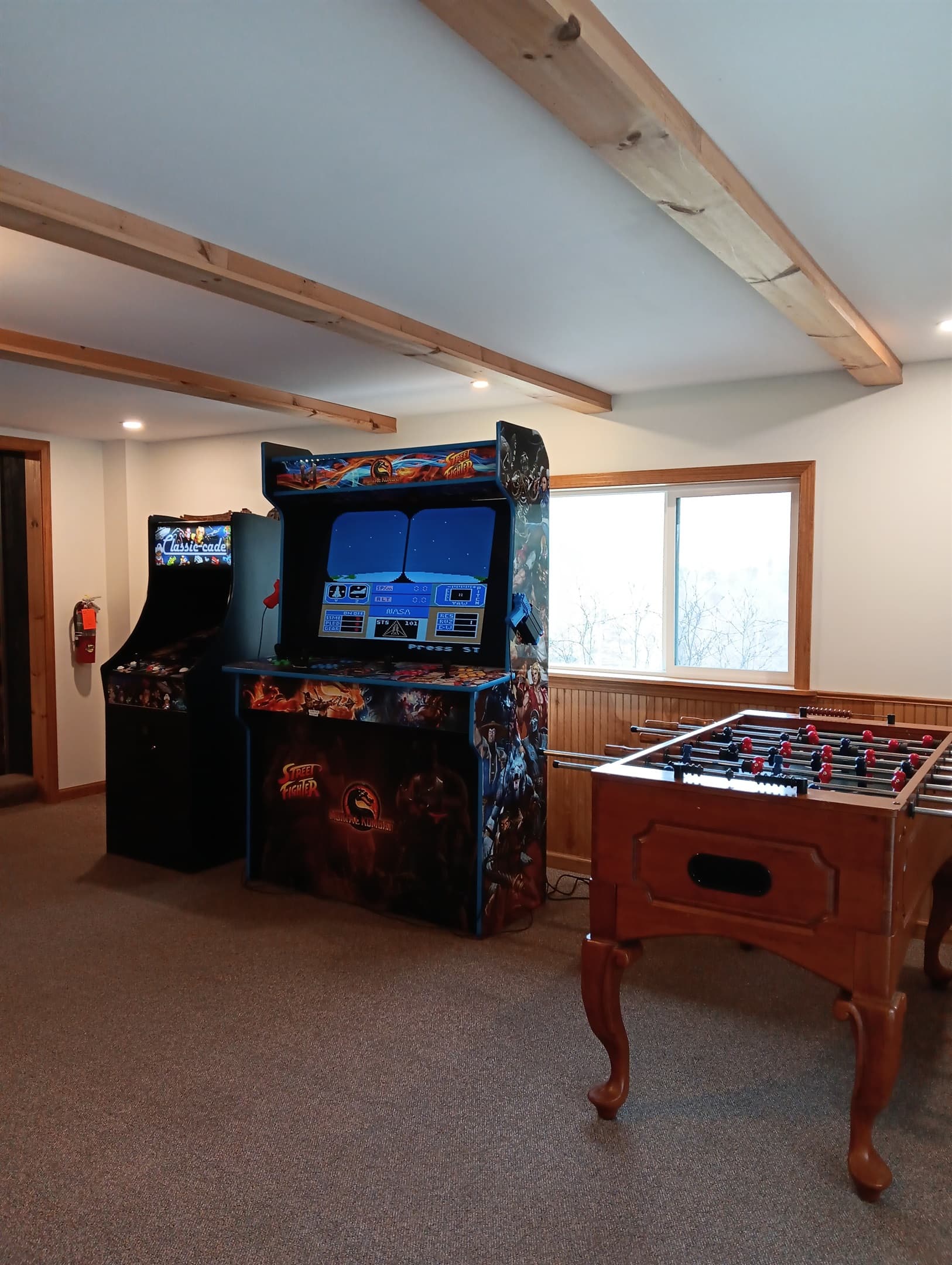 Arcade games beside foosball table 